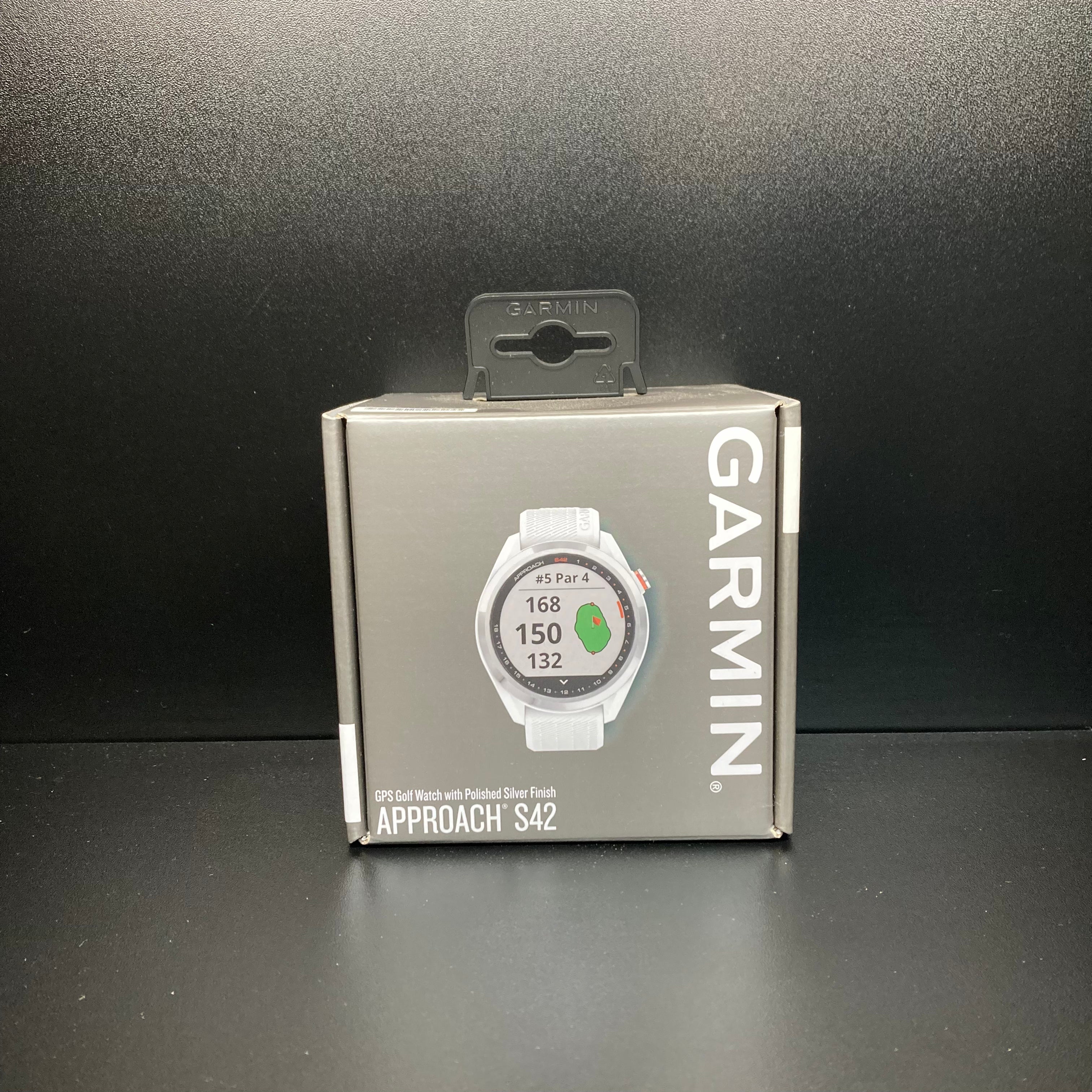 Garmin S42 GPS golf watch with digital display, showing time and golf tracking features on a sleek black band.