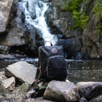 Large standard backpack by Backcountry Sportsman, shown in dark color with multiple compartments and padded shoulder straps.