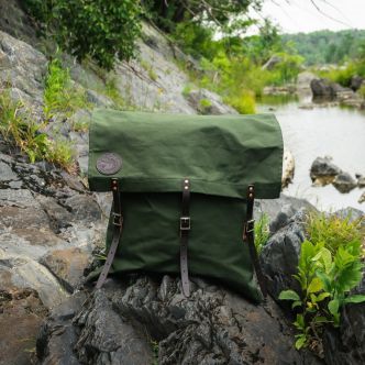 Backcountry Sportsman 60 Utility Pack in 57L, shown in outdoor setting with adjustable straps and multiple compartments.