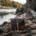 Backcountry Sportsman Heritage Leather Medium Shell Purse featuring waxed bison leather and classic design, shown in a natural outdoor setting.