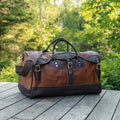 Backcountry Sportsman Bison Leather Sportsman's Duffel bag with sturdy handles and leather exterior, suitable for travel and outdoor adventures.