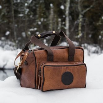Backcountry Sportsman Bison Leather Range Bag with sturdy leather construction and multiple compartments for outdoor shooting gear.