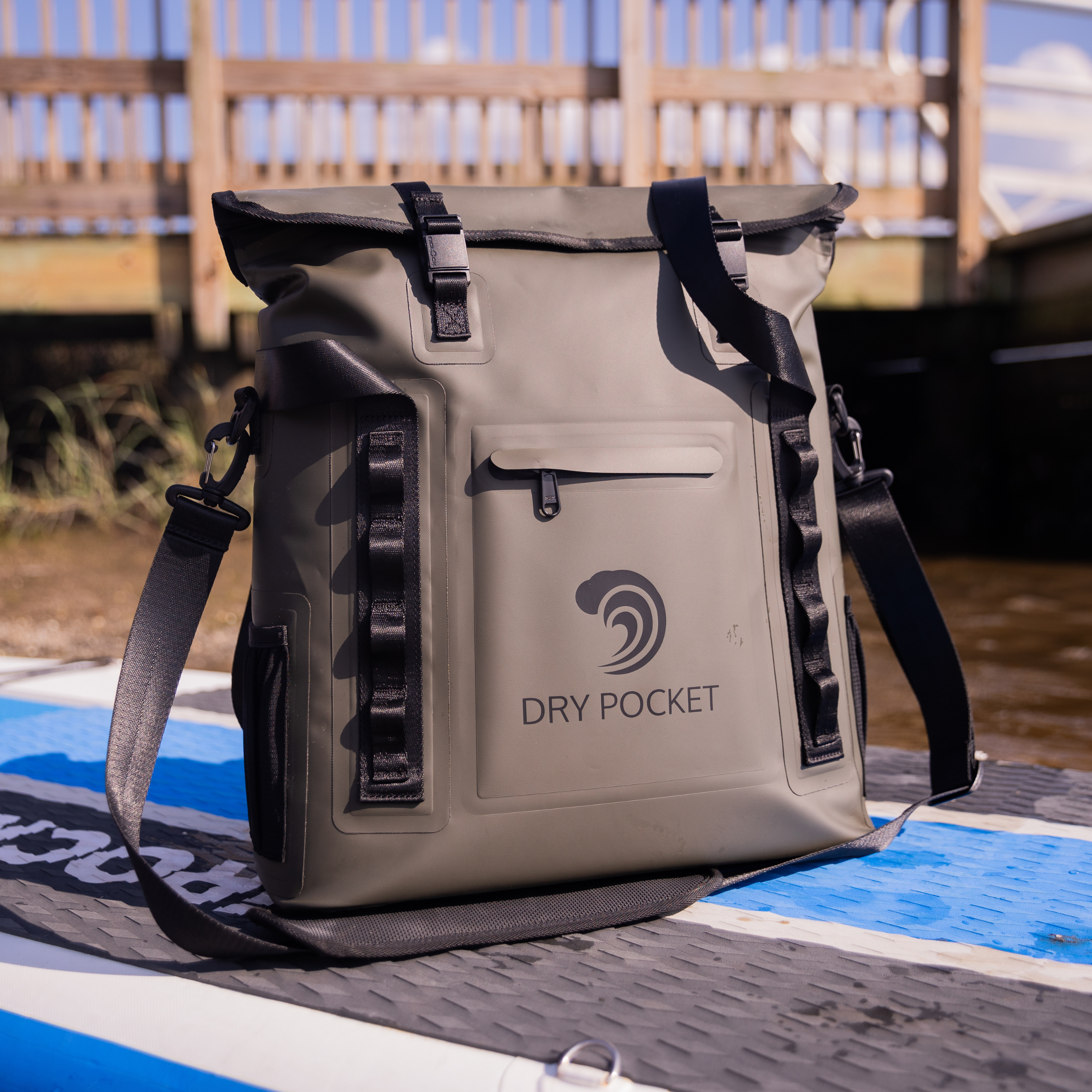 Green Dry Pocket waterproof floating tote cooler with auto-sealing lid, designed for outdoor and aquatic activities.