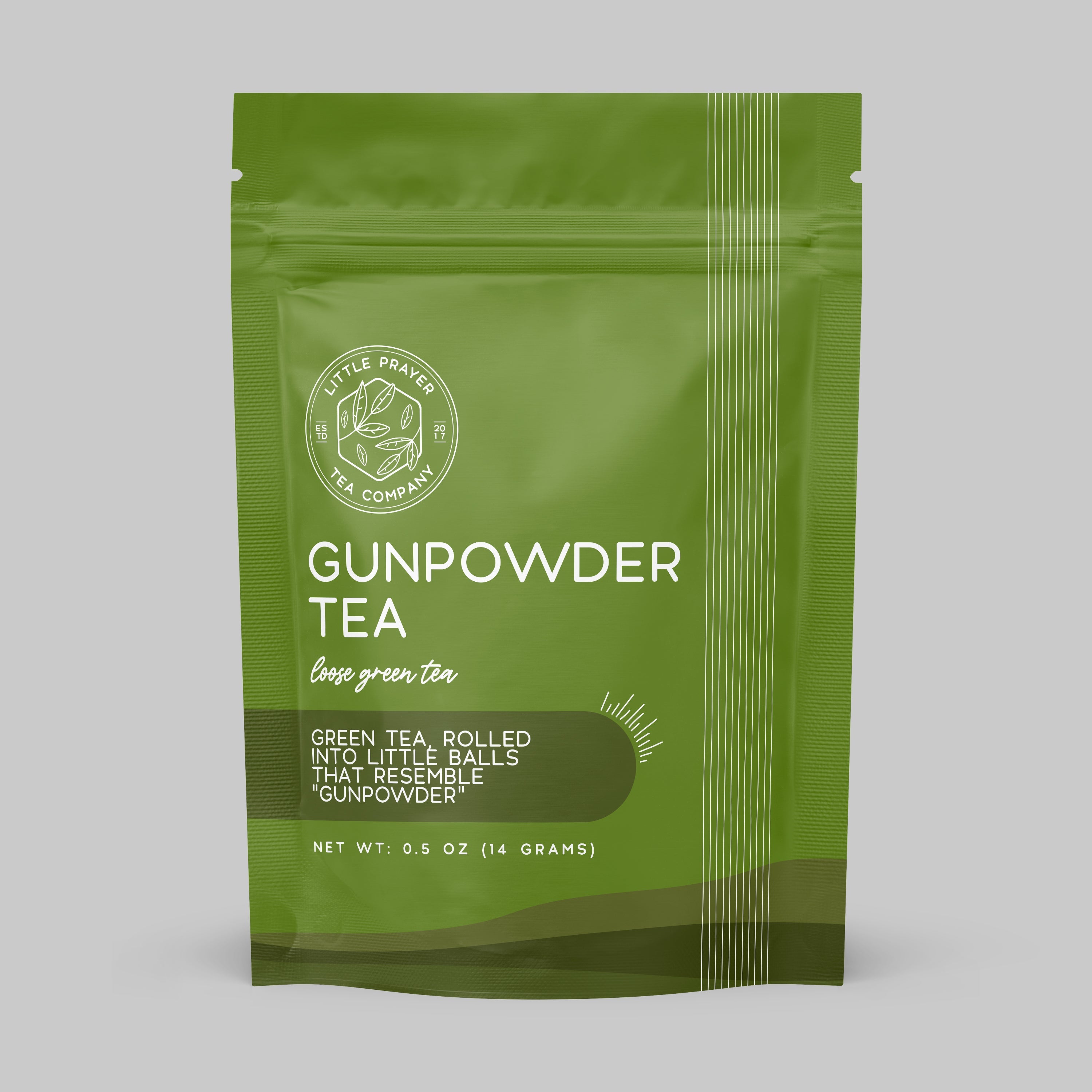 Sample of Gunpowder green tea from Little Prayer Tea Company, showcasing tightly rolled tea leaves in a clear glass container.