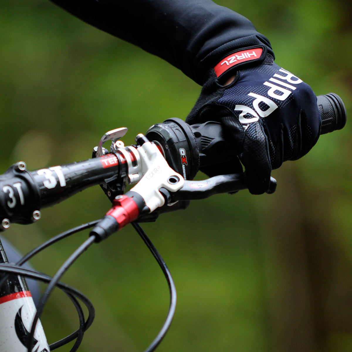ZEITBIKE HIRZL Tour FF 1.0 leather bike gloves, close-up of black gloves with reinforced palms and adjustable wrist straps.