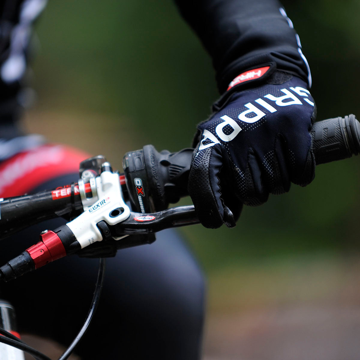 ZEITBIKE HIRZL Tour FF 1.0 leather bike gloves, close-up of black gloves with textured leather and reinforced palm details.
