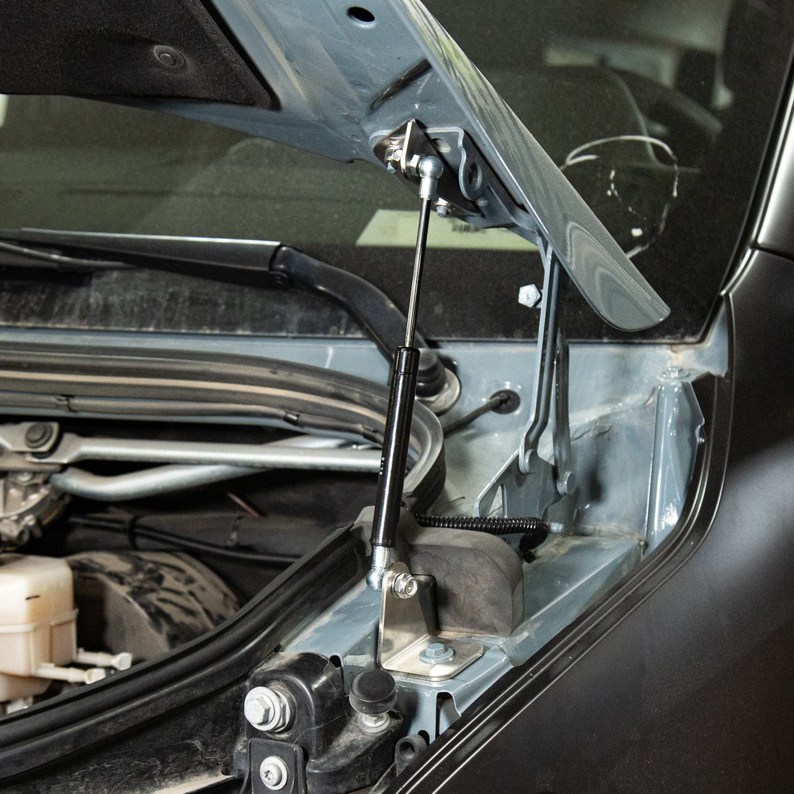Sprinter Hydraulic Hood Strut Kit by Vanspeed Performance, showcasing the struts installed on a vehicle hood.