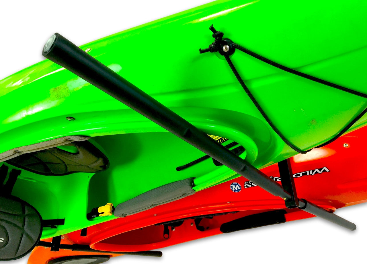 Green and red kayak with a black paddle holder on a white background