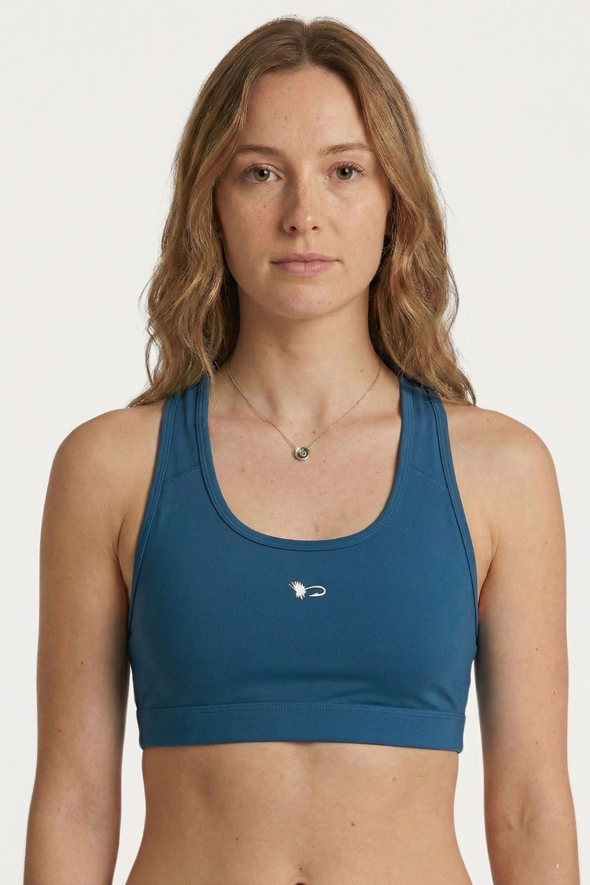 FisheWear HaliBorealis sports bra with vibrant blue and green patterns, designed for active wear and support during workouts.