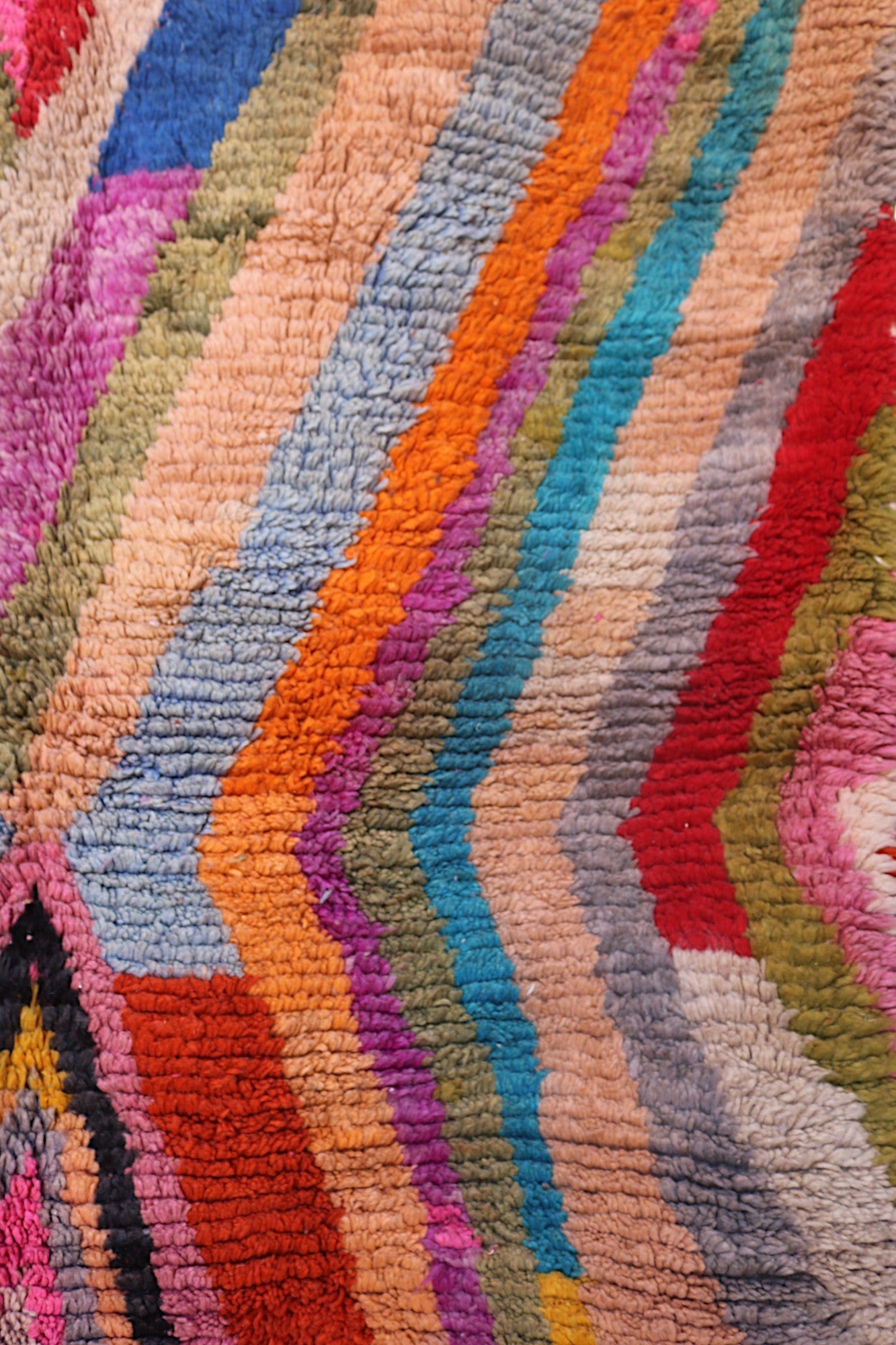Handmade Moroccan wool rug by LoomSouk featuring vibrant rainbow colors and a unique Berber design.