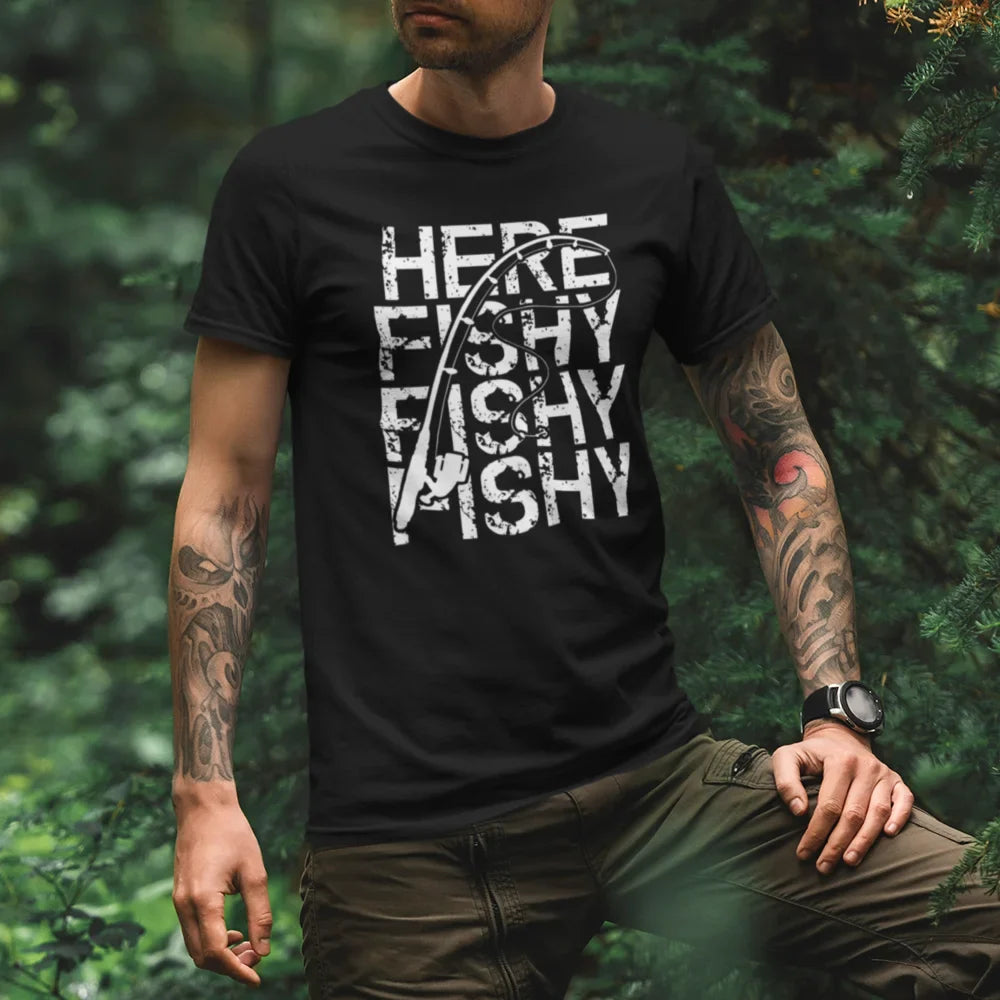 Black Here Fishy Fishy man T-shirt by Outdoorzees featuring a playful fish graphic on the front.