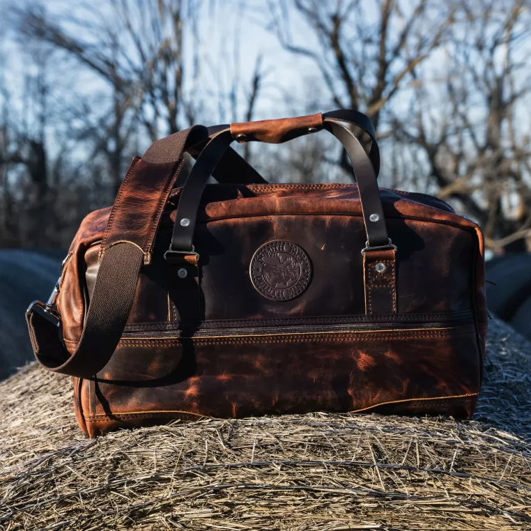 Heritage Leather Weekender Duffel bag by Backcountry Sportsman, made of premium leather with sturdy handles and spacious interior for travel.
