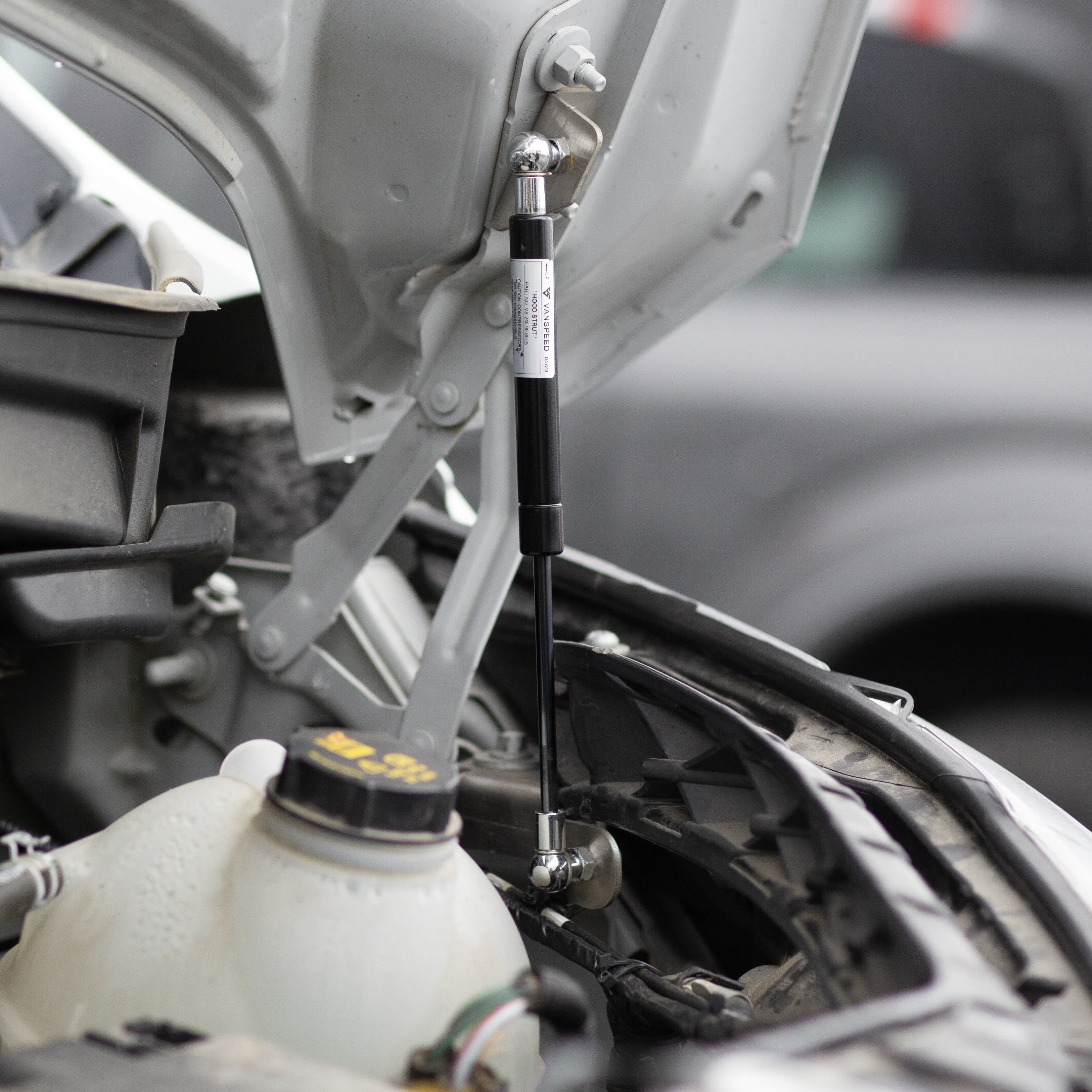 Vanspeed Performance Transit Hydraulic Hood Strut Kit installed, showing sleek design and sturdy support for vehicle hood.