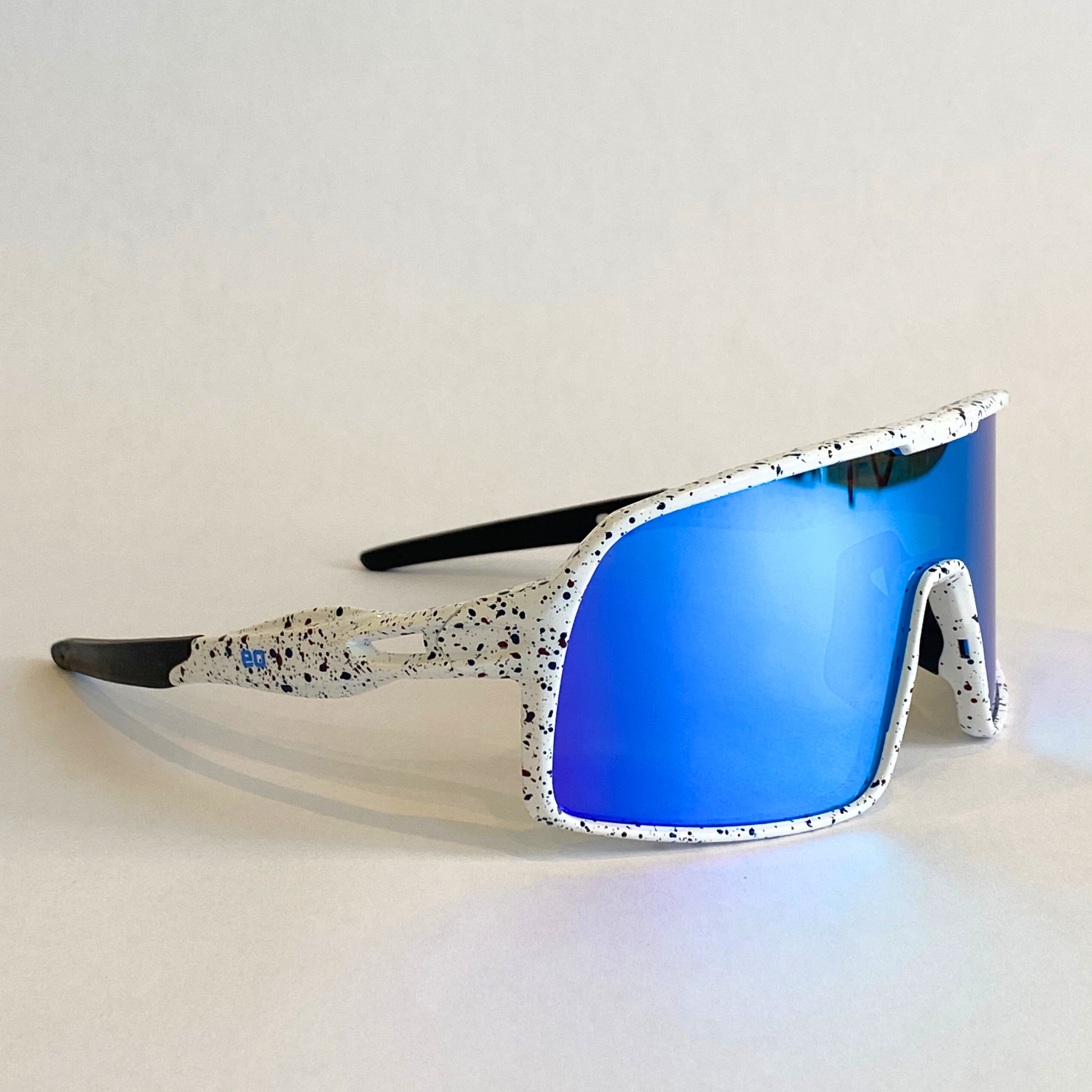 Flying Dog Snowstorm sunglasses with blue-mirror Revo lens, shown from a right-angle side view.