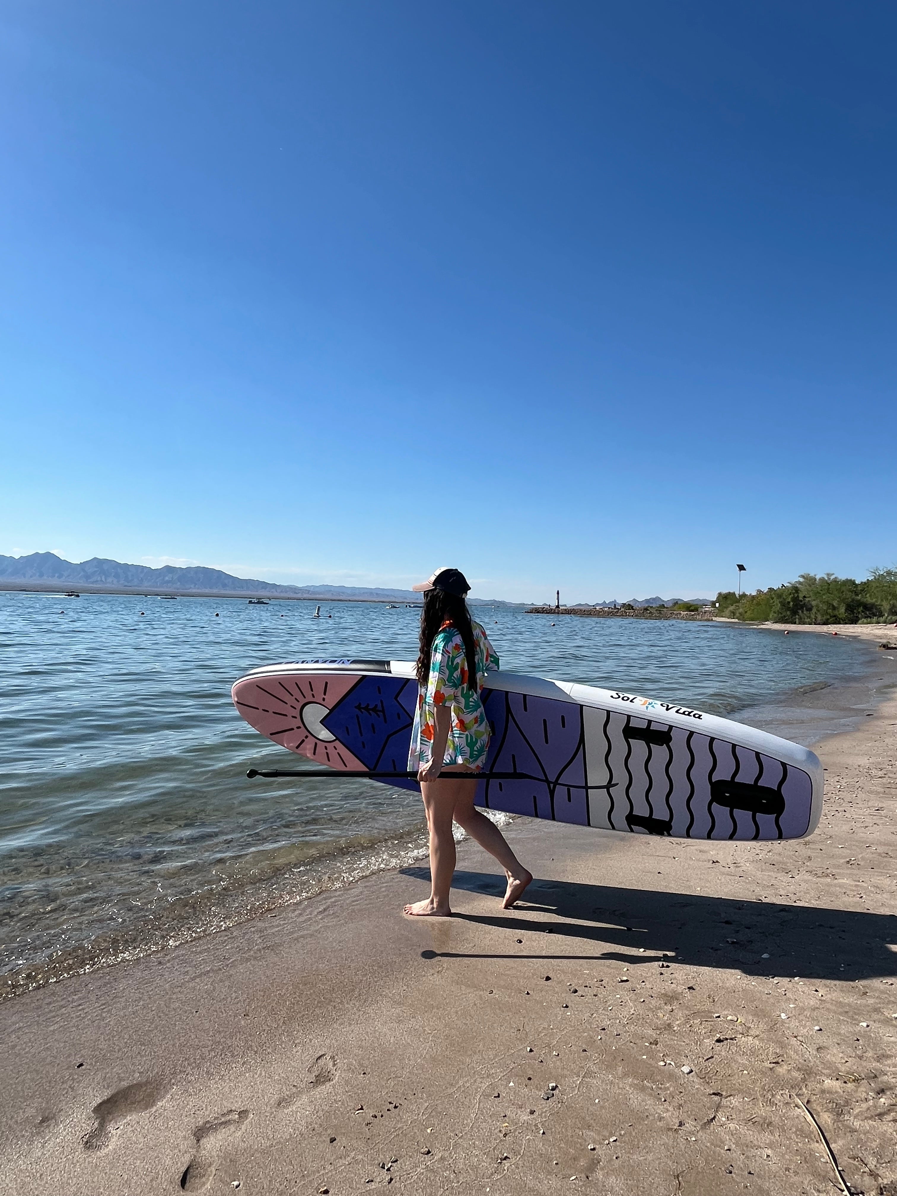 SolVida VidaGlide 10'6" inflatable stand-up paddleboard with paddle and accessories in a complete water sports package.