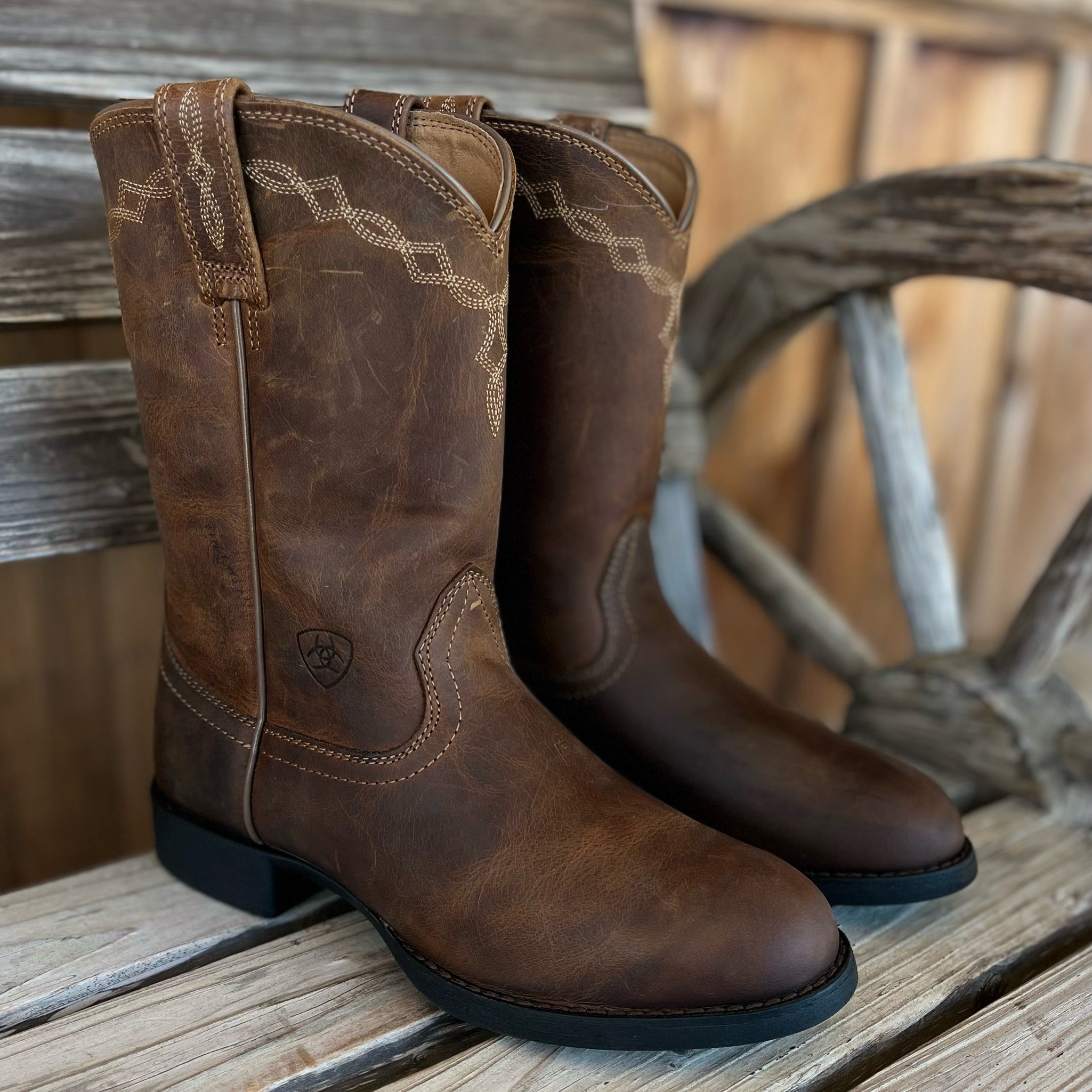 A pair of brown Ariat Heritage Roper women's Western boots with classic stitching and Western-style design.