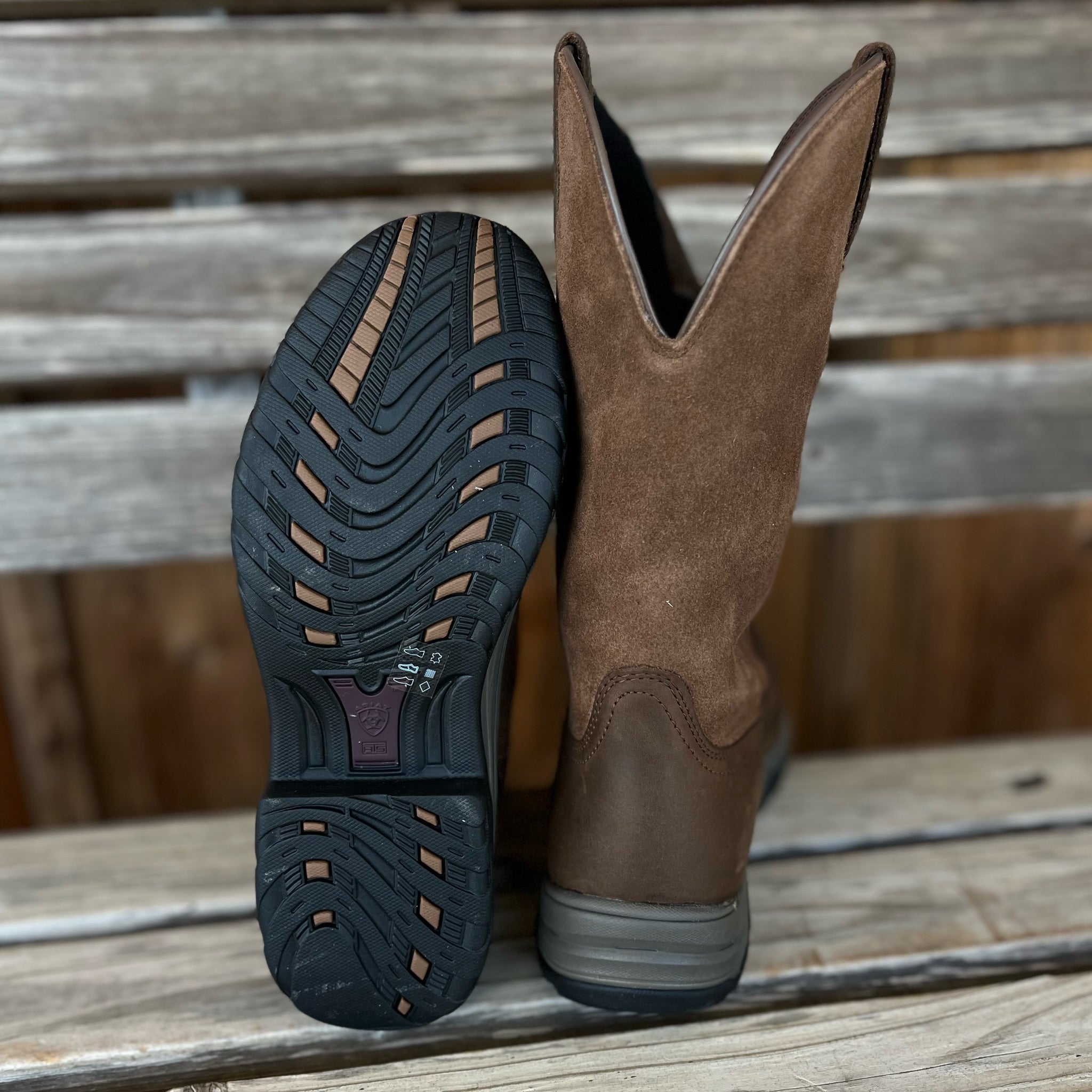 A pair of black Ariat Womens Pull-On Terrain H20 Western Boots with rugged soles and waterproof leather, suitable for outdoor wear.