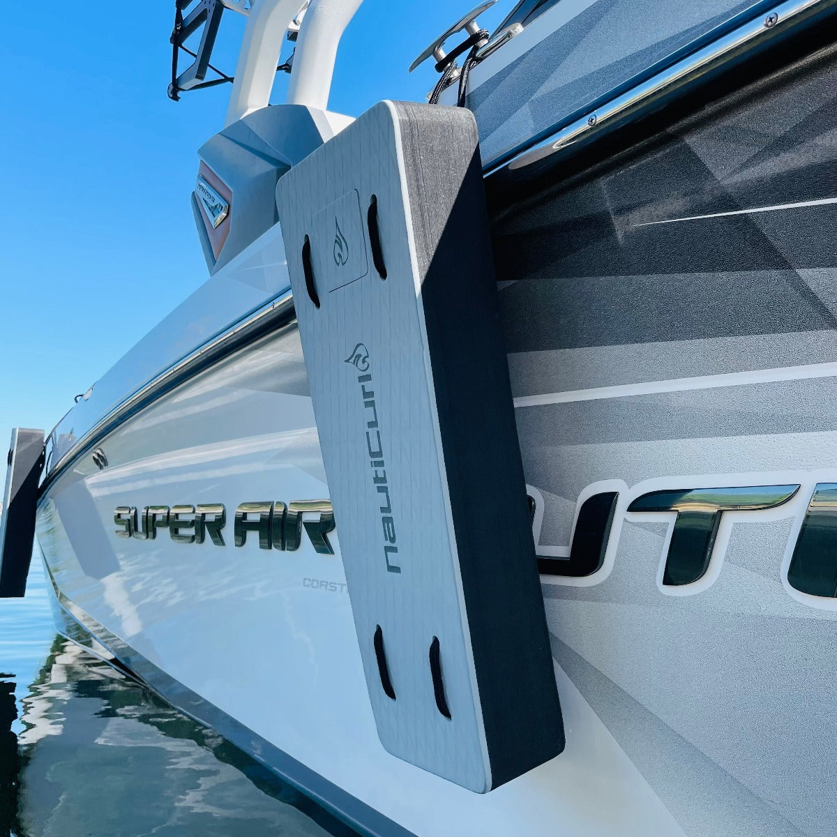 NautiFender flat boat fender by NautiCurl LLC with a cylindrical shape and white color, designed to protect boats from impact.