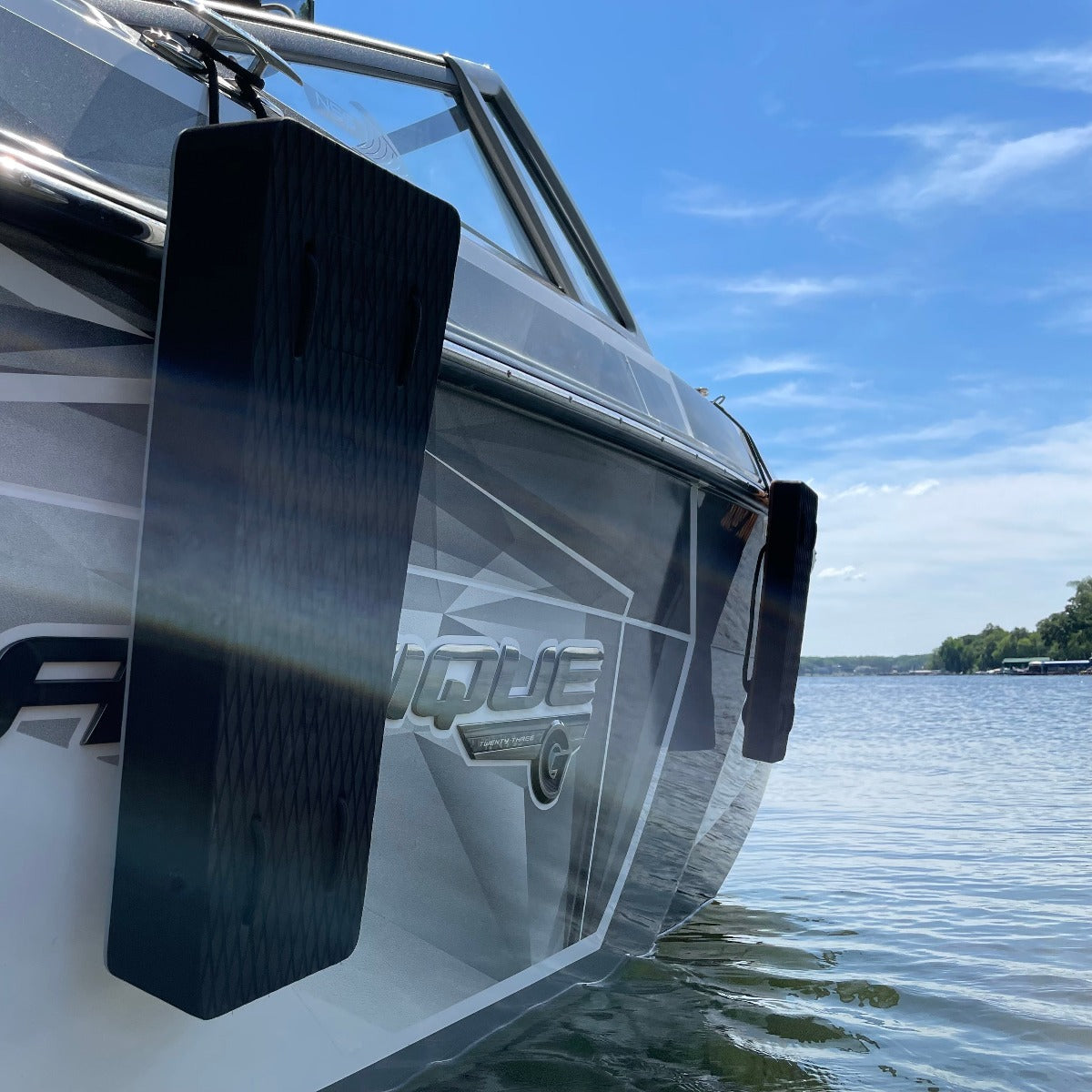 NautiFender flat boat fender by NautiCurl LLC hanging on a boat, made of durable material to protect hulls from damage.