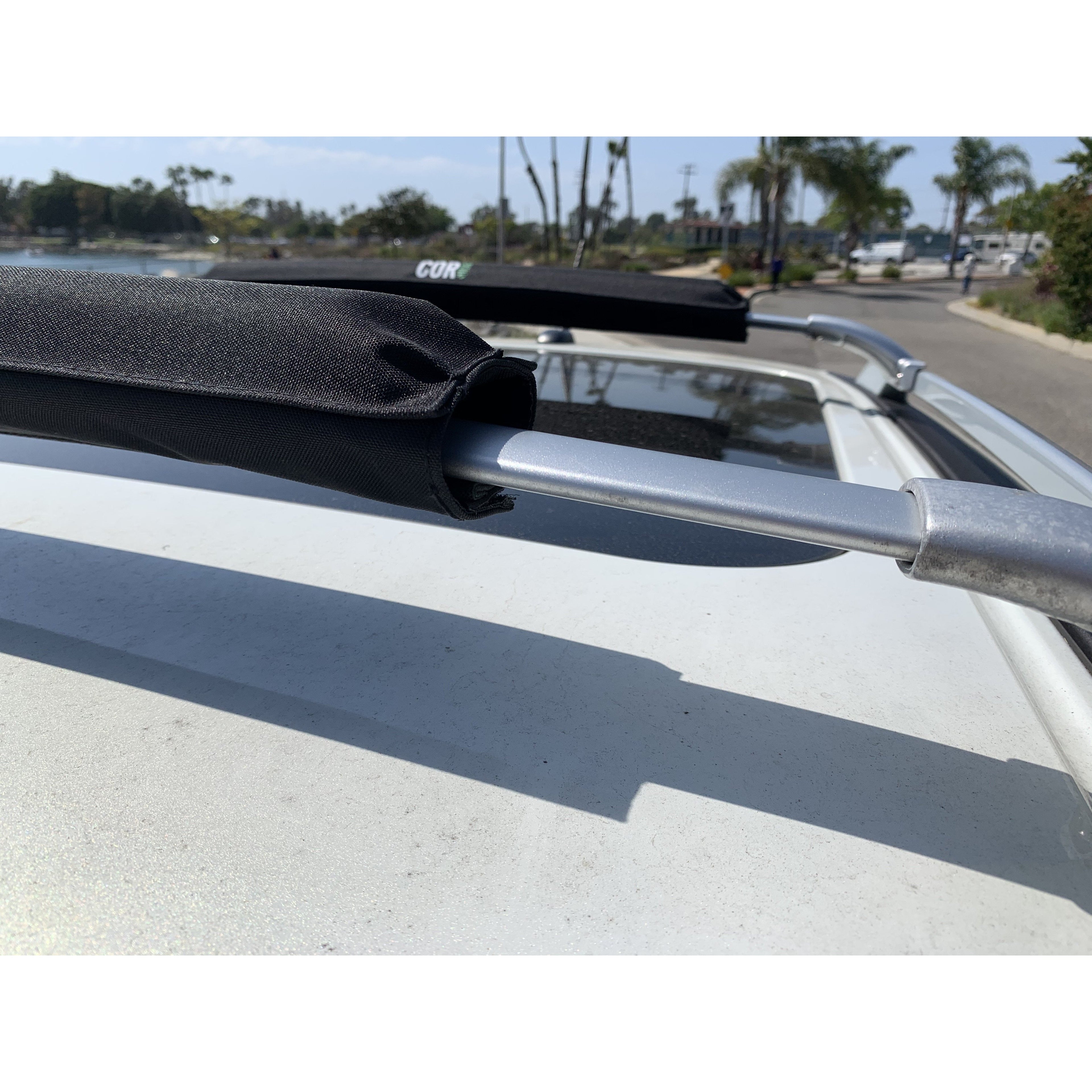 COR Surf Aero Roof Rack Pads in 28" and 19" sizes on narrow flat bars for vehicle roof rack accessories.