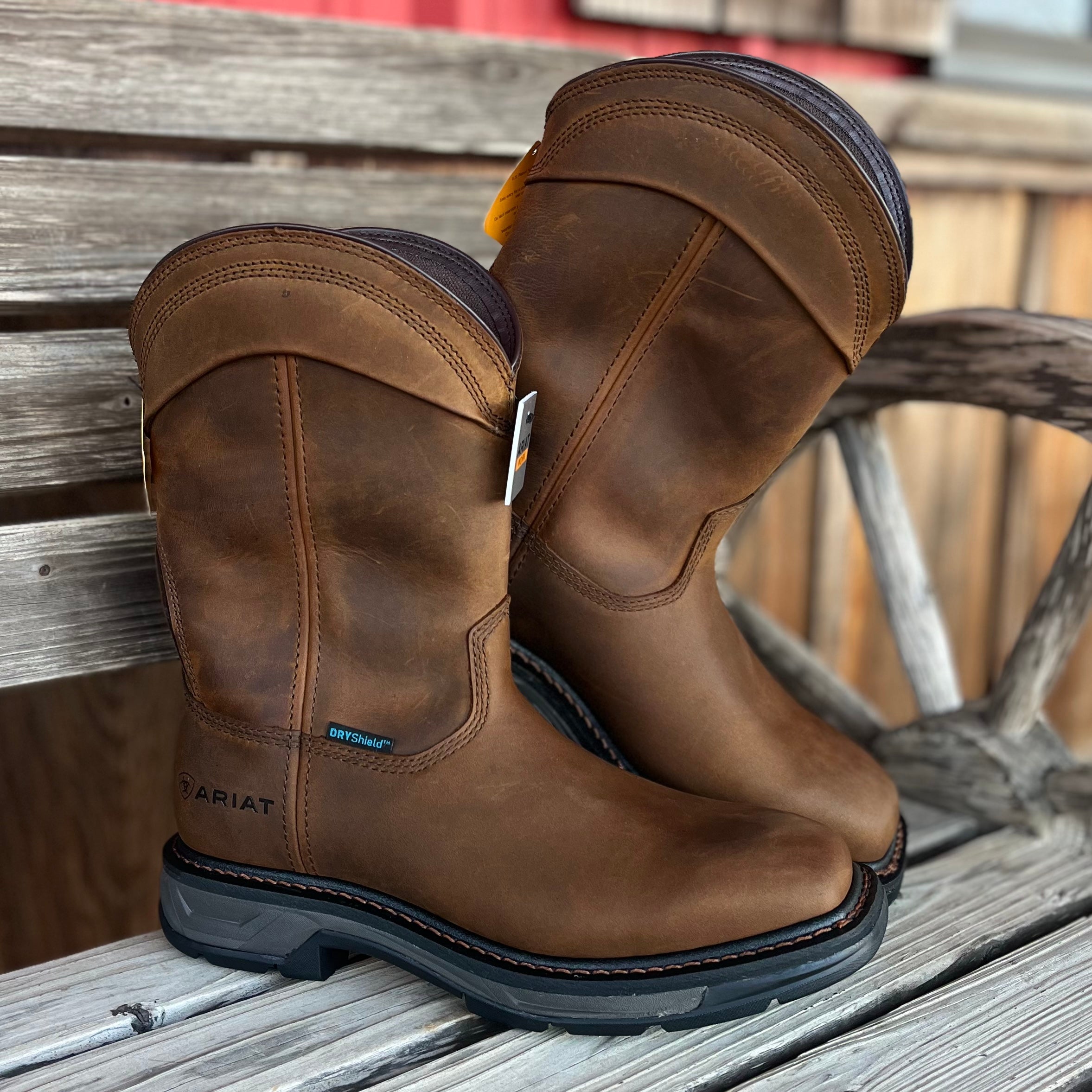 Pair of brown work boots on a wooden surface