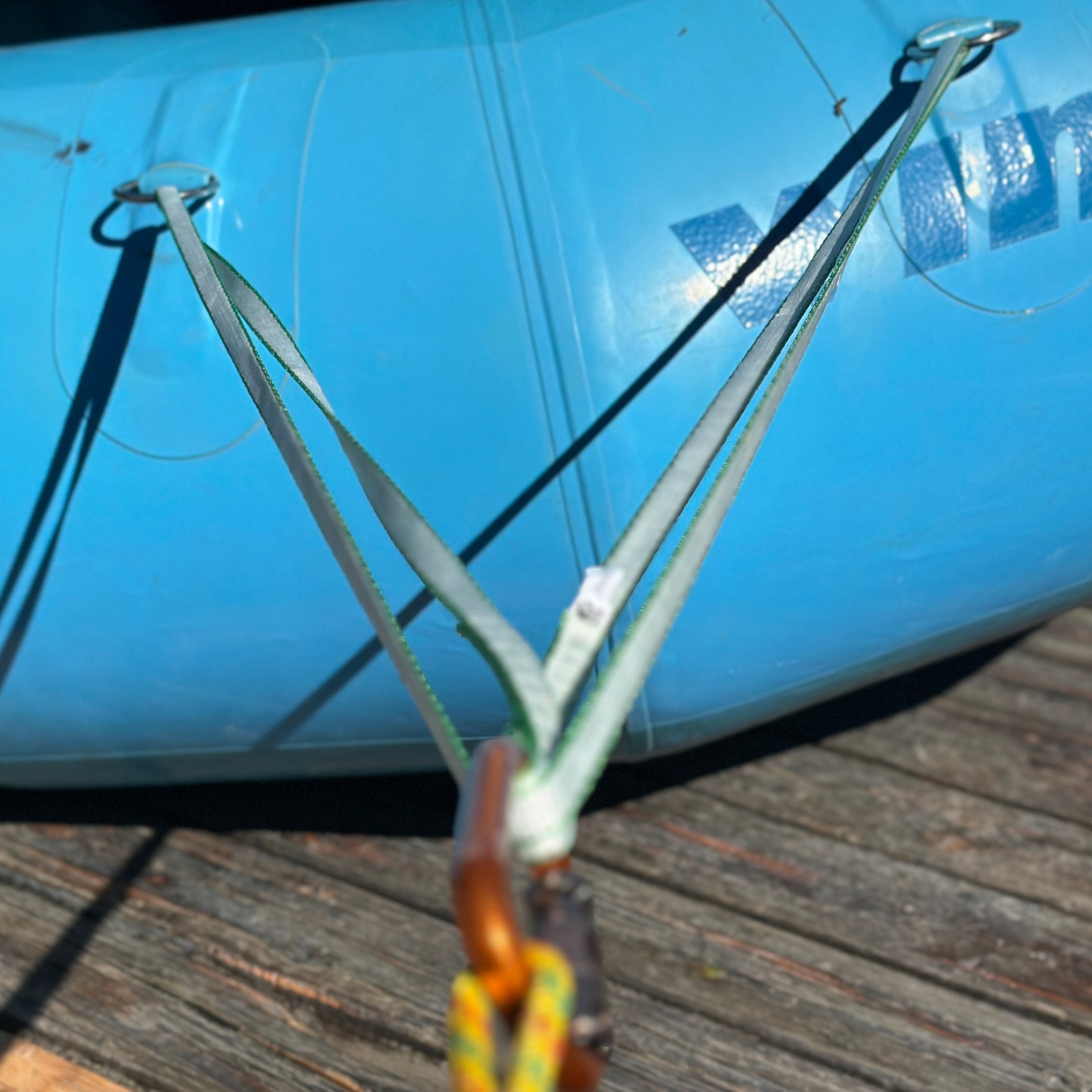 River Hardware rafting flip line, durable safety rope for whitewater rafting, shown coiled with secure clips and handles.
