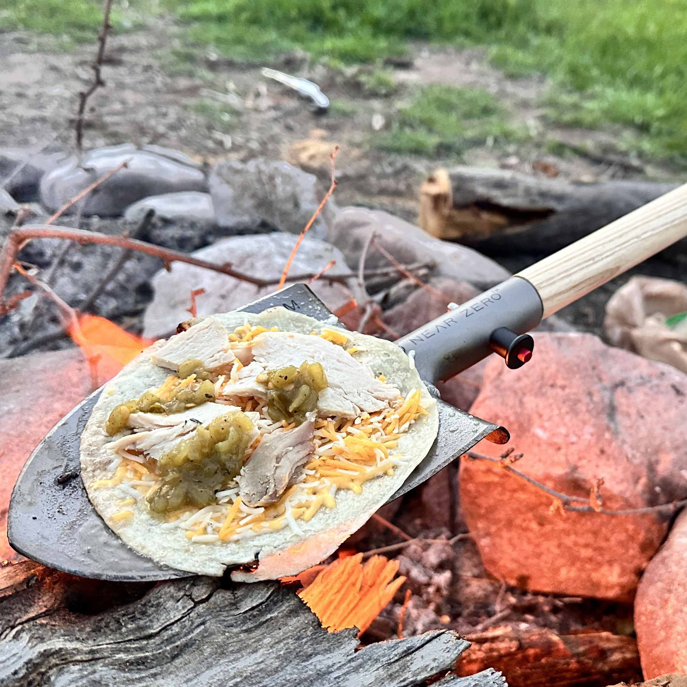 Near Zero Outdoor Gear titanium shovel, a durable accessory with a sturdy blade and ergonomic handle for outdoor digging tasks.