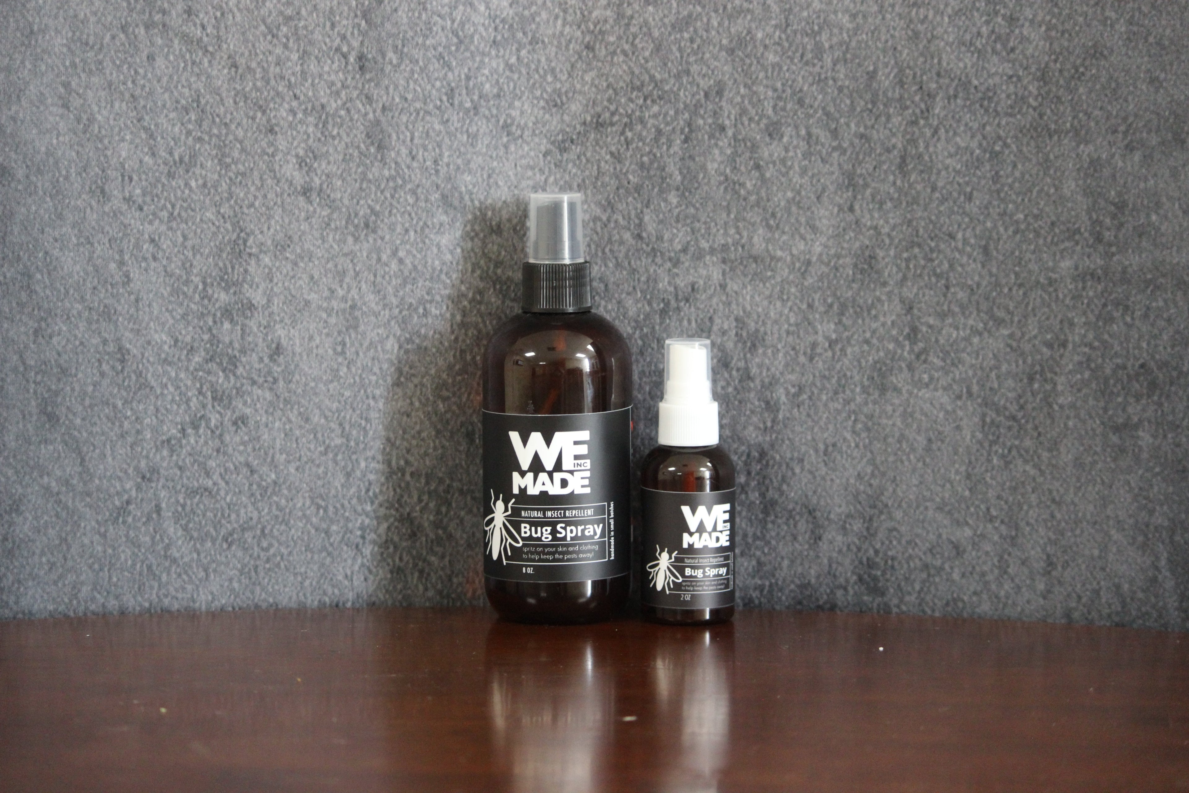 WE Made bug spray in a 2 oz. bottle with a spray nozzle, designed to repel insects effectively.