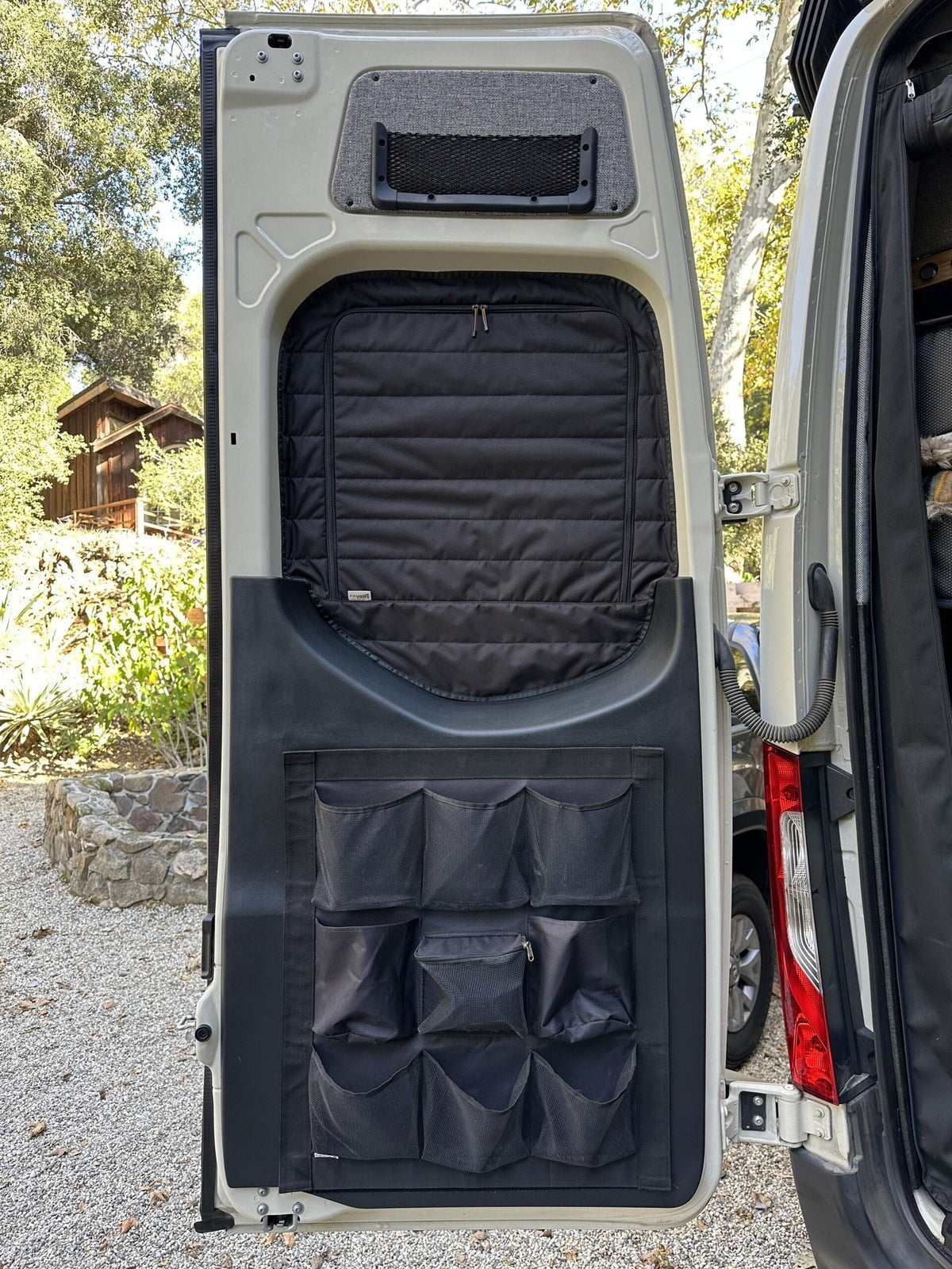 Canyon Adventure Vans CLIMA-SHADE™ insulated rear window covers set in a van interior, showcasing their fit and design.