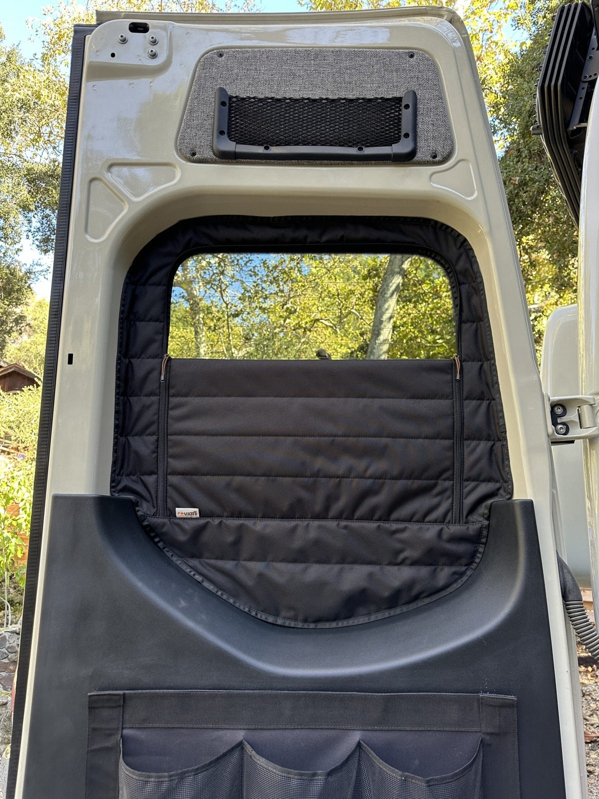 Canyon Adventure Vans CLIMA-SHADE™ insulated rear window covers set, showcasing a snug fit and thermal protection design.