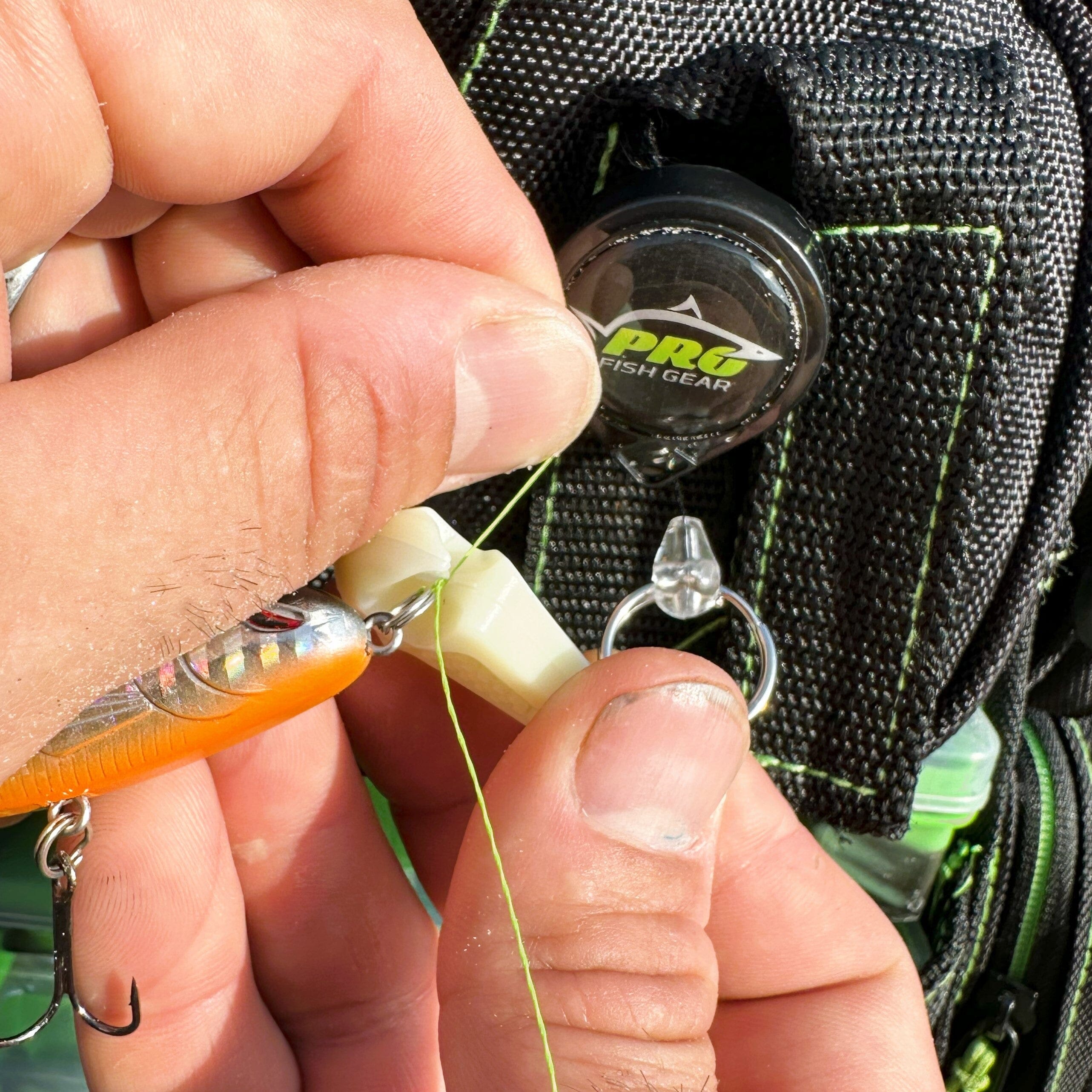 Line Cutterz glow-in-the-dark zipper pull featuring a ceramic blade design for easy access and functionality.