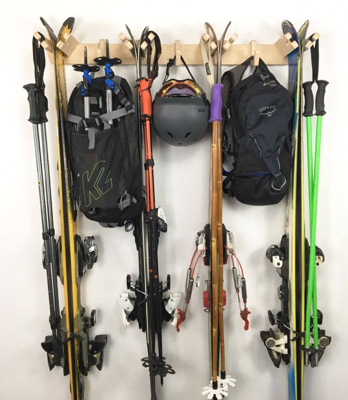 Rado Racks THE APRES ski wall rack holding skis and ski poles, mounted on a wall for organized winter sports gear storage.