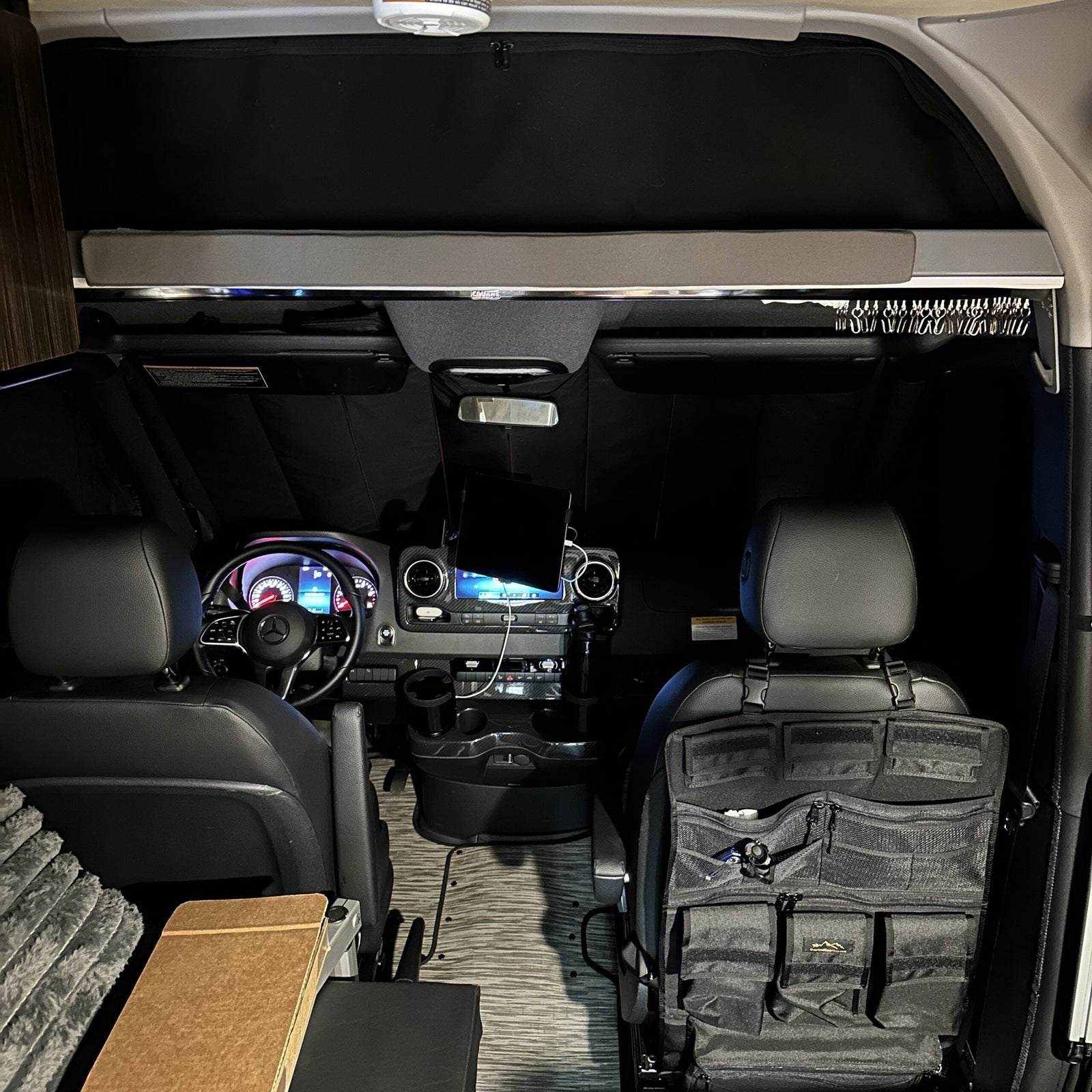 Canyon Adventure Vans CLIMA-SHADE™ insulated front windshield cover on a vehicle to block sun and keep interior cool.