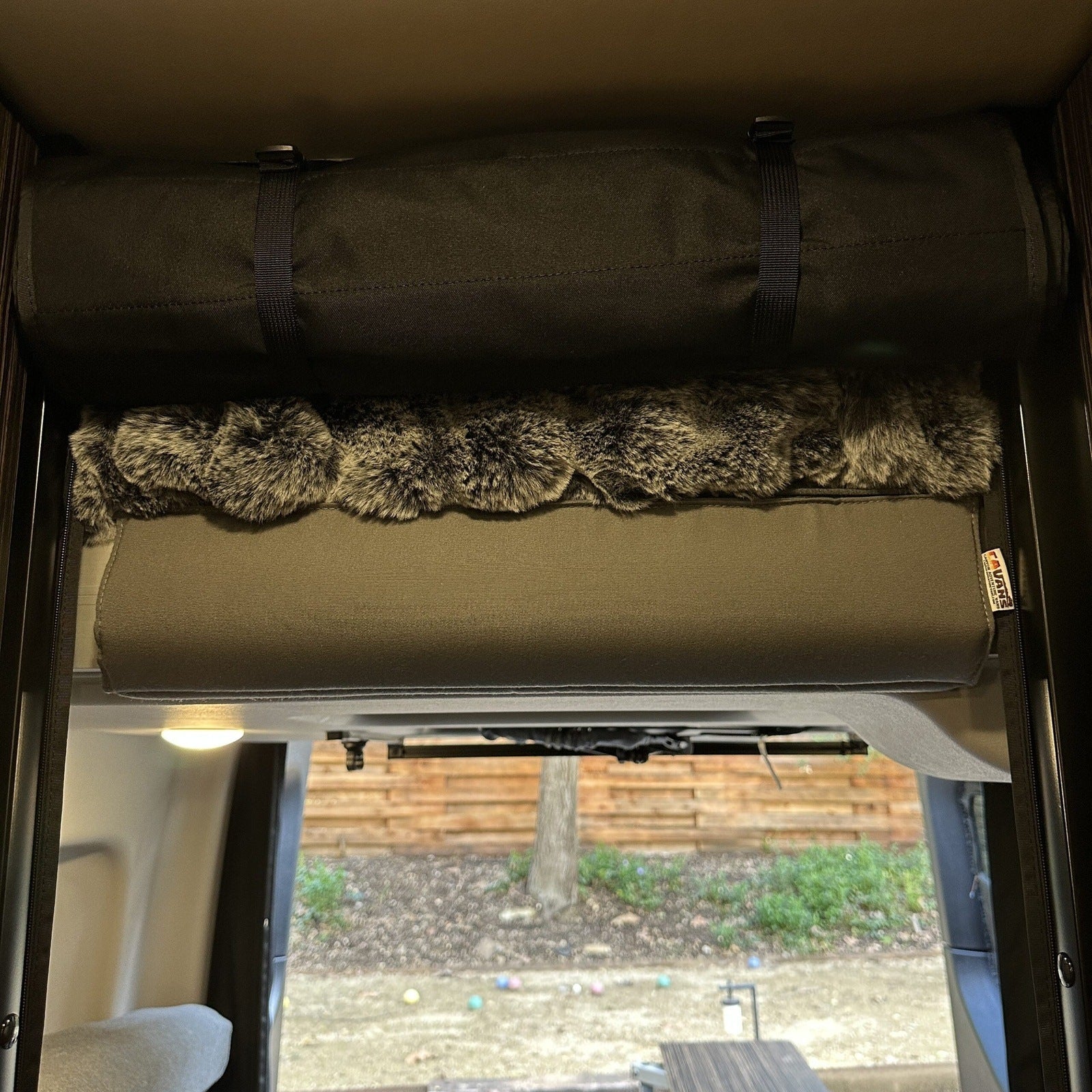 Canyon Adventure Vans head bumper bed for 2019+ REVEL, CAV branded, shown installed in a camper van interior.