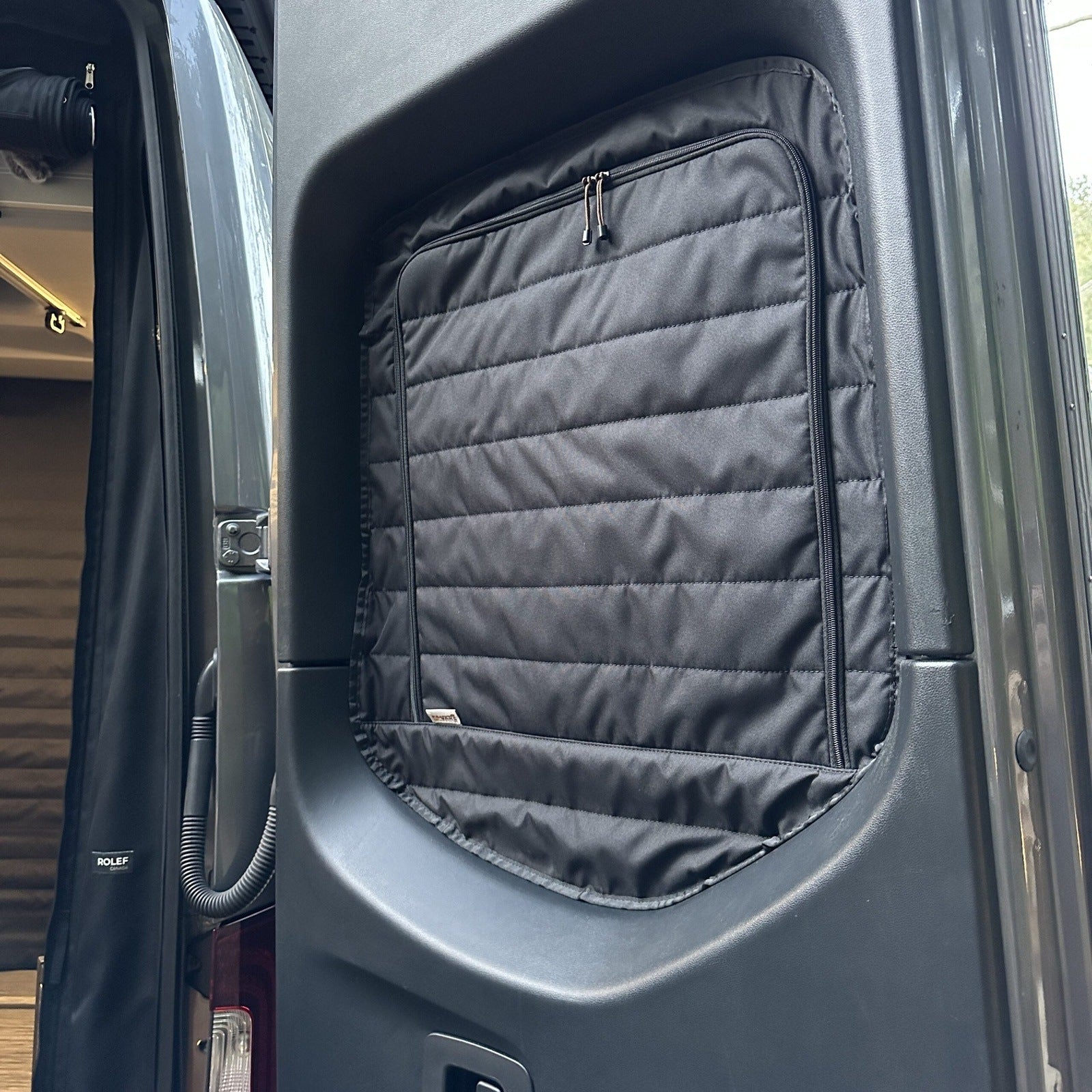 CLIMA-SHADE™ insulated rear window covers for vans, featuring a sleek design by Canyon Adventure Vans.