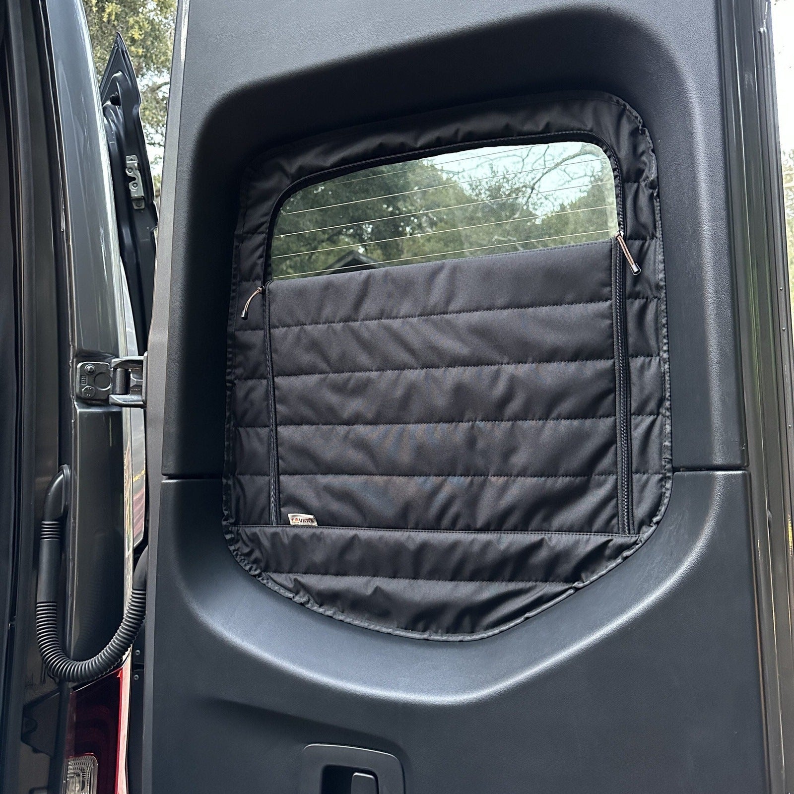 Canyon Adventure Vans CLIMA-SHADE™ insulated rear window covers set displayed in a van interior.