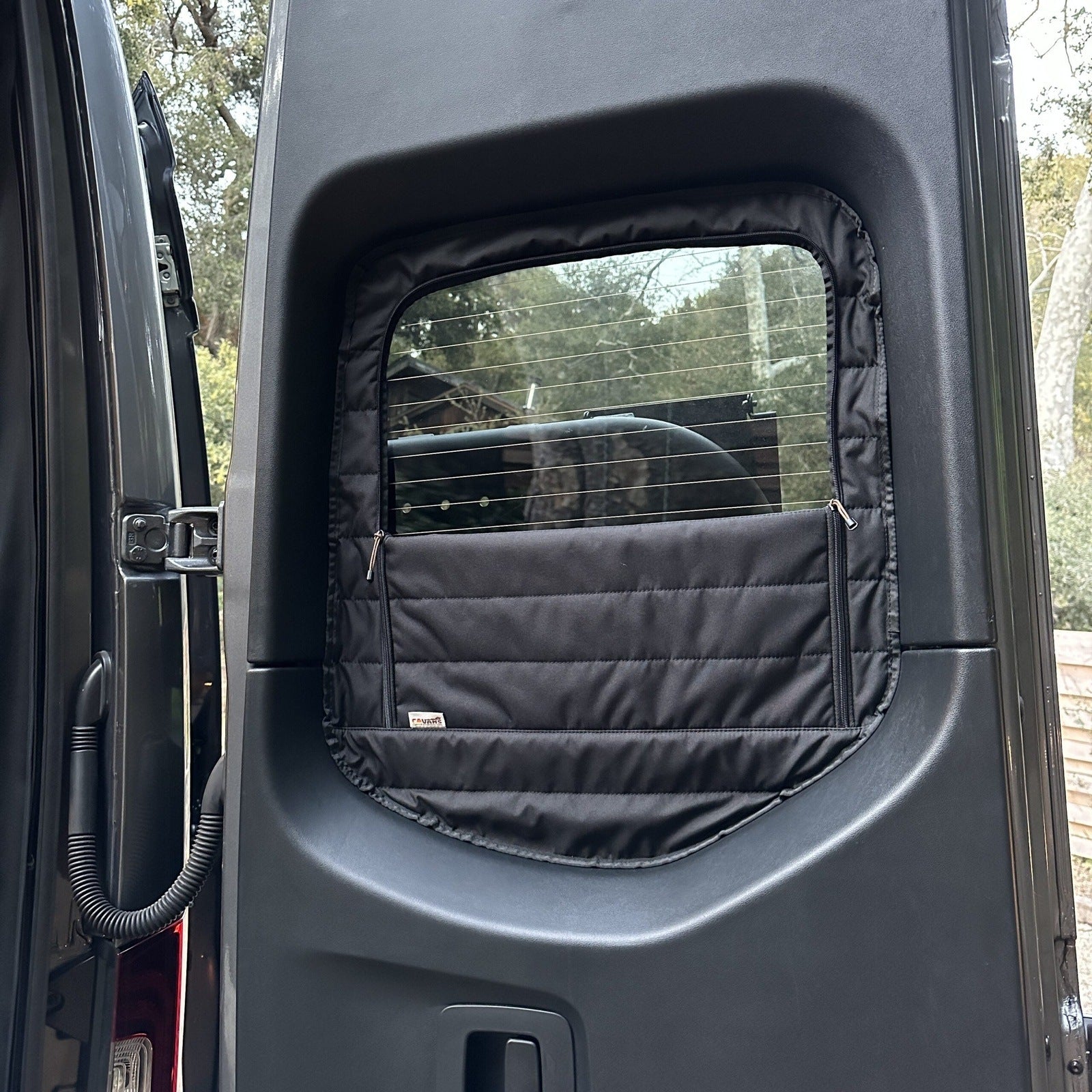Canyon Adventure Vans CLIMA-SHADE™ insulated rear window covers set displayed in a van interior.