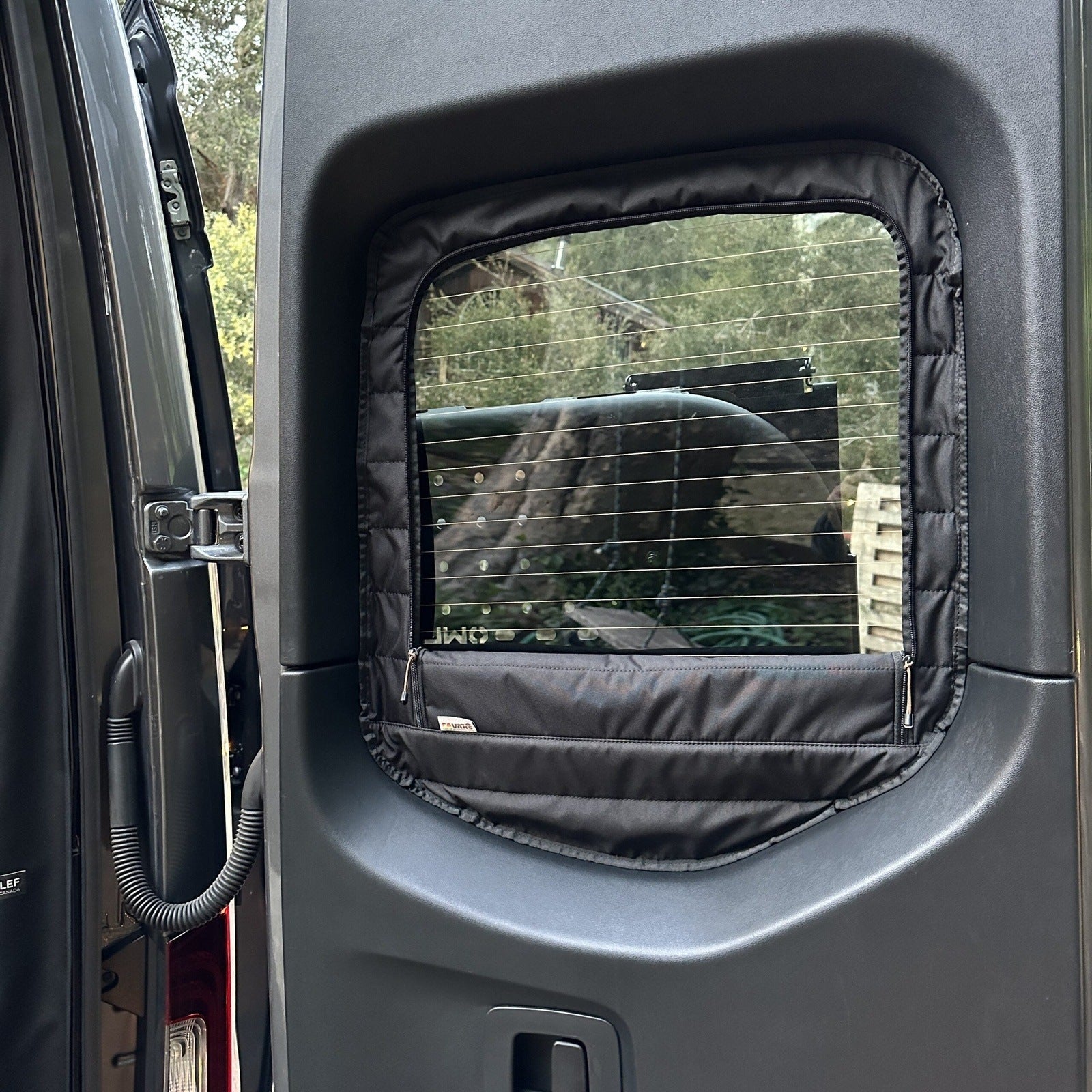 Canyon Adventure Vans CLIMA-SHADE™ insulated rear window covers set displayed in a van interior for optimal sun protection.