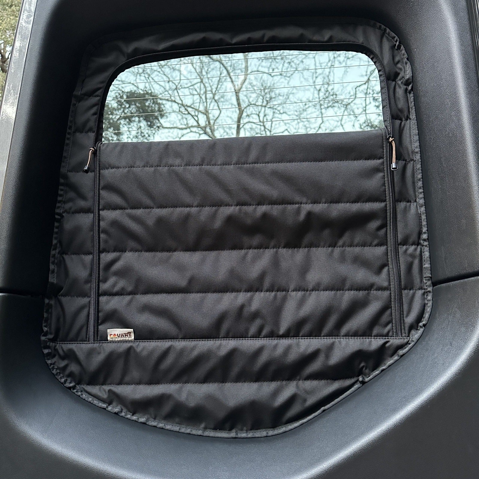 Canyon Adventure Vans CLIMA-SHADE™ insulated rear window covers set in a van, showcasing their fit and design.