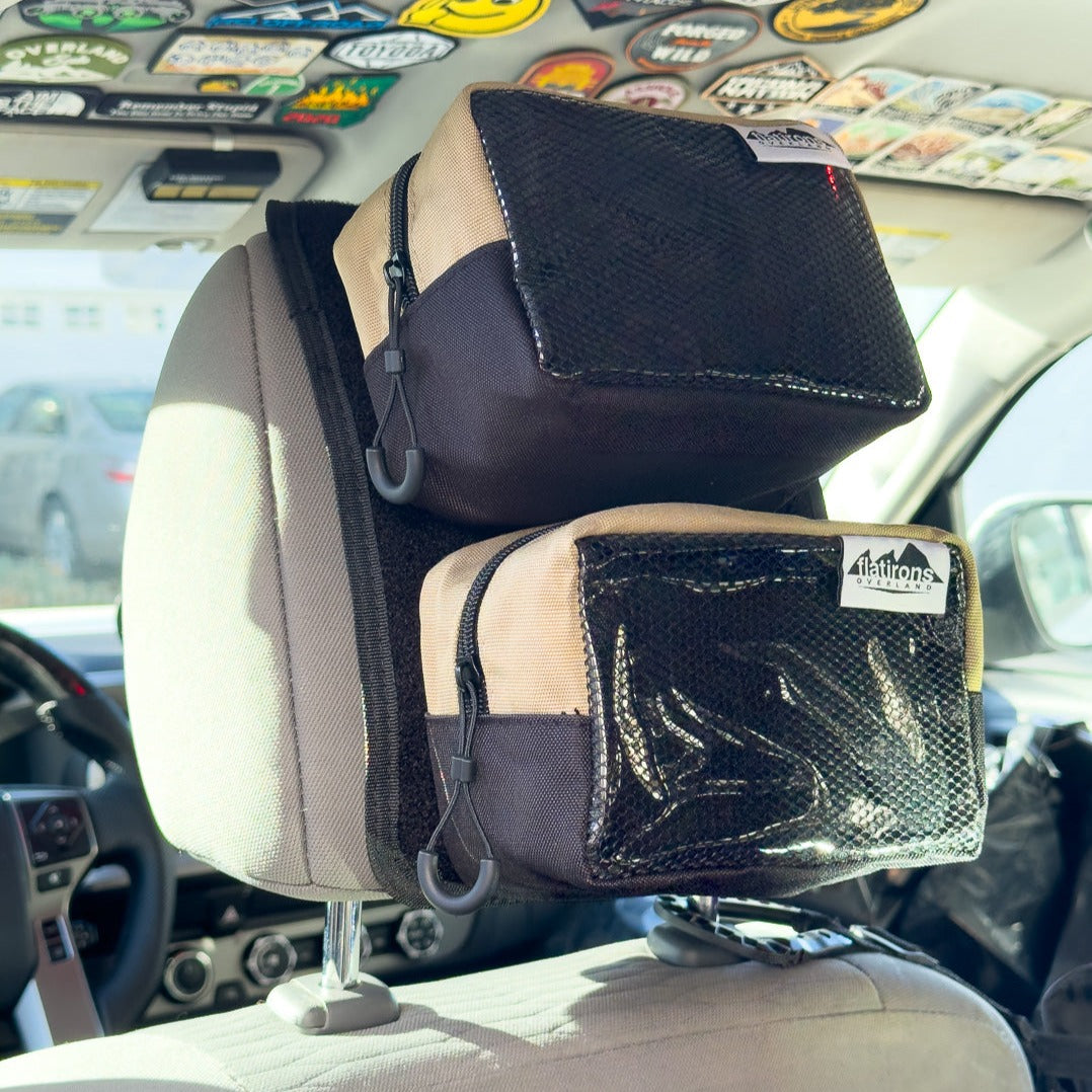 Flatirons Overland RiPouch™ headrest organizer with multiple storage compartments attached to a vehicle headrest.