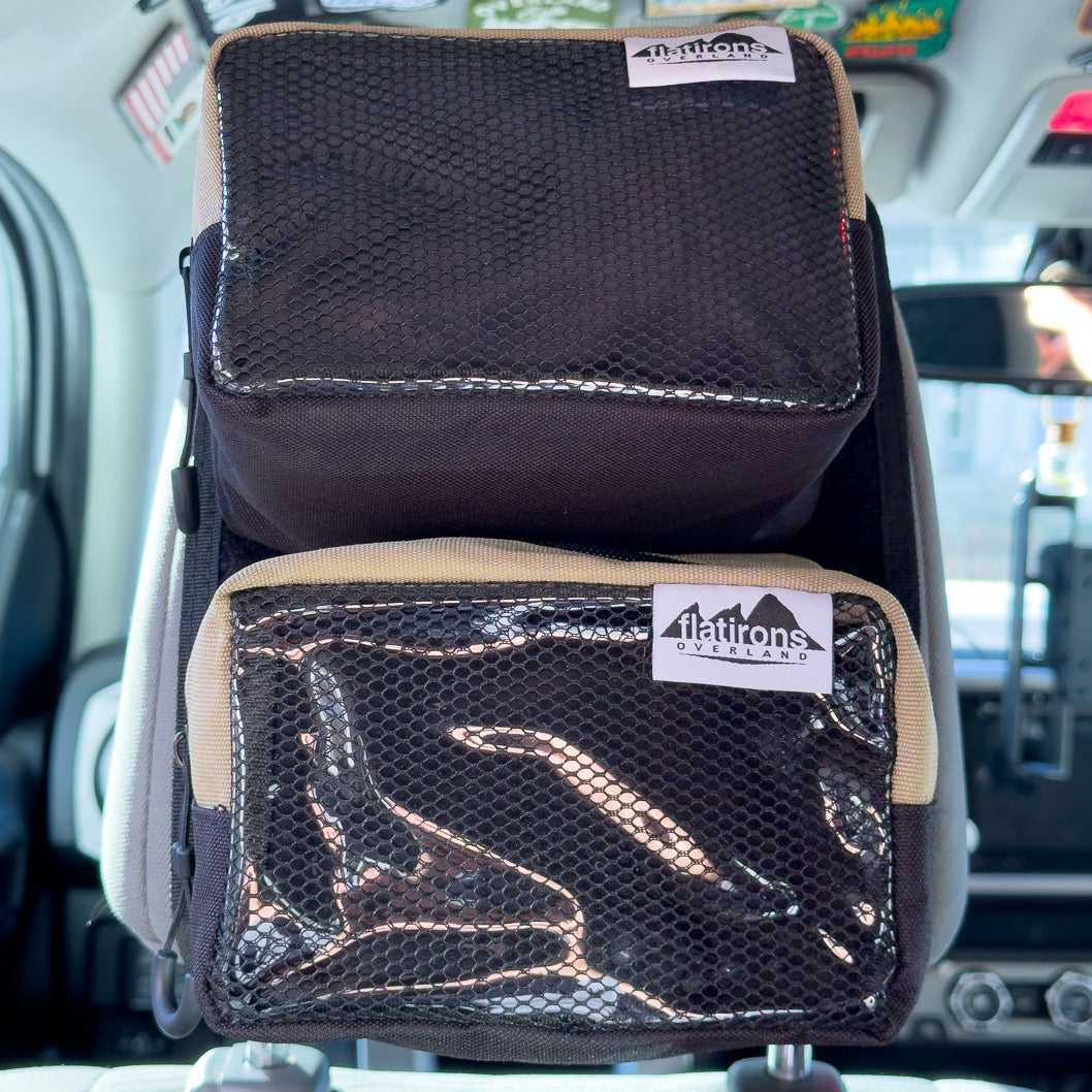 Flatirons Overland RiPouch™ Headrest Organizer hanging on car seat headrest with multiple storage compartments.