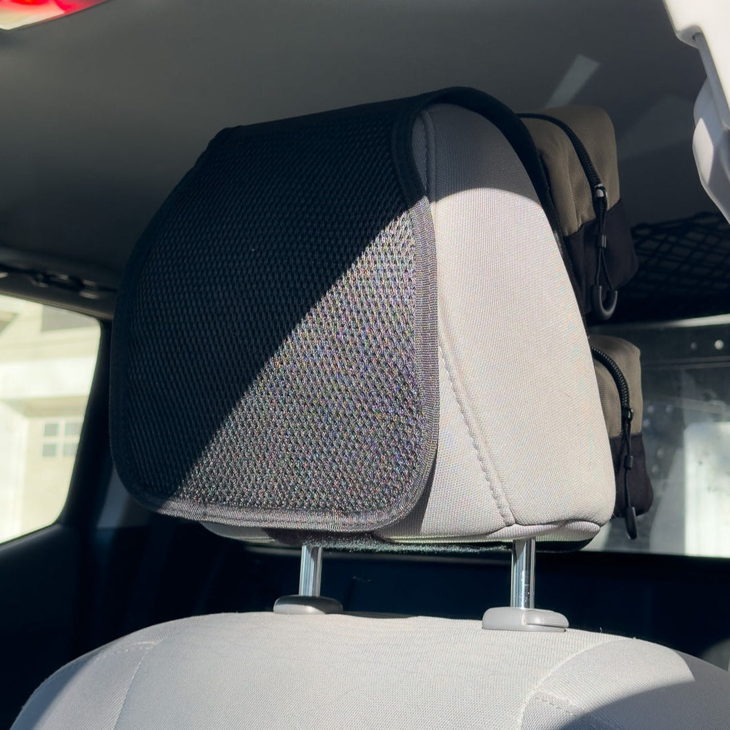 Flatirons Overland RiPouch™ headrest organizer with multiple storage pockets attached to car headrest.