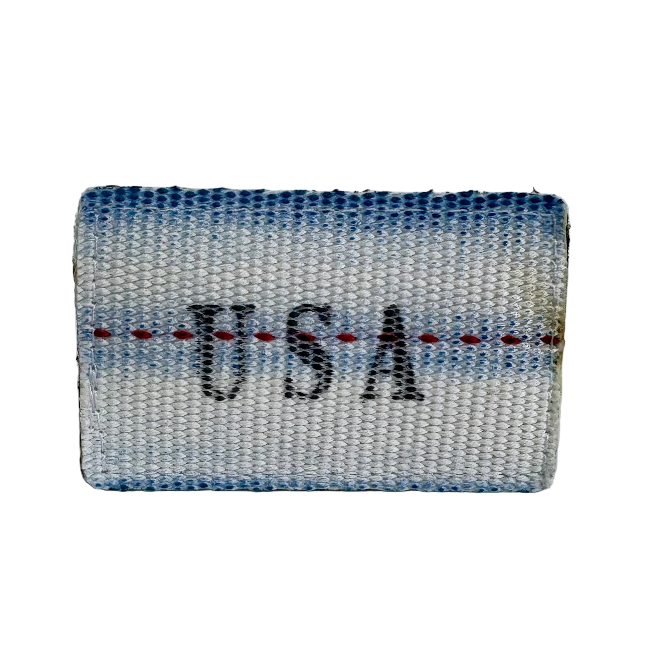 Recycled Firefighter Firehose Patch featuring a colorful firefighter emblem on fabric background