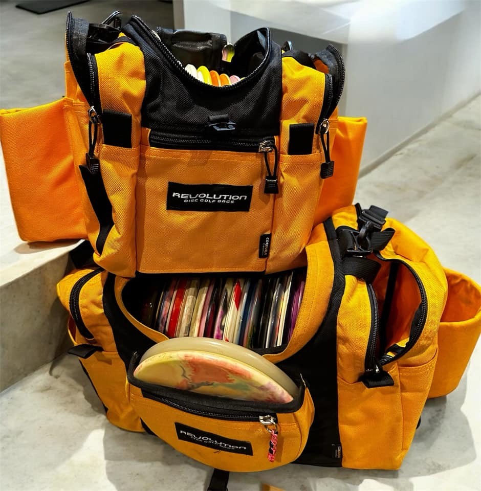 Gotta Go Gotta Throw Revolution Mini Deluxe V3 disc golf bag in golden dream color, showing multiple disc compartments and adjustable straps.