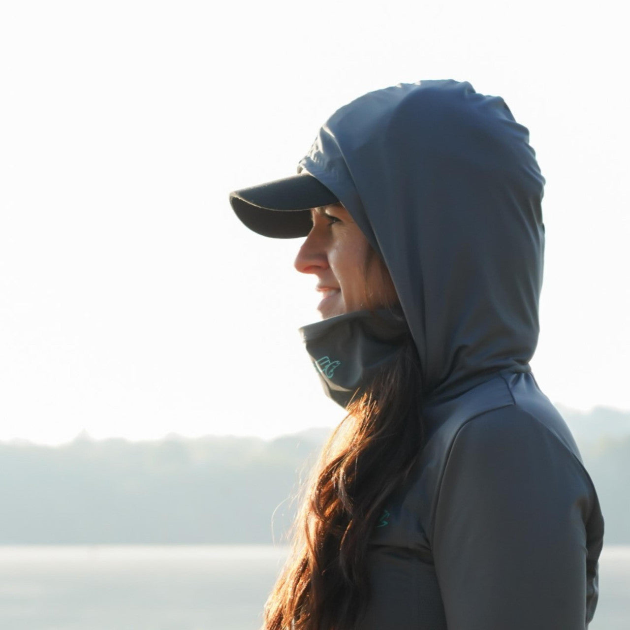 Chloe hooded shirt by DSG OUTERWEAR with UPF 50+ sun protection, shown in a casual outdoor setting.