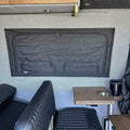 Canyon Adventure Vans CLIMA-SHADE™ insulated groove lounge window cover installed on a van window, providing shade and insulation.