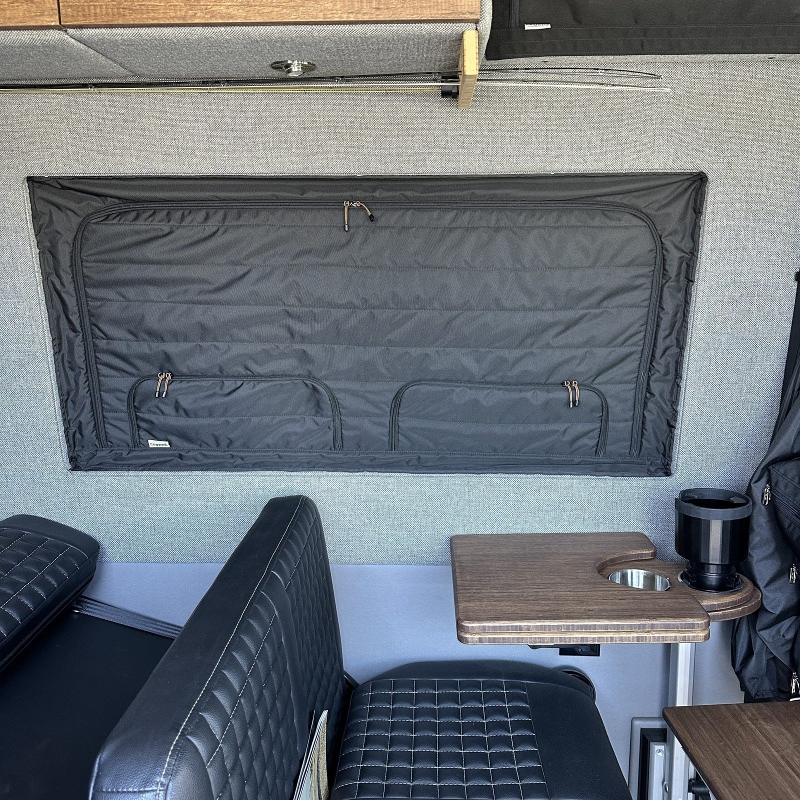 Canyon Adventure Vans CLIMA-SHADE™ insulated groove lounge window cover installed on a van window, providing shade and insulation.