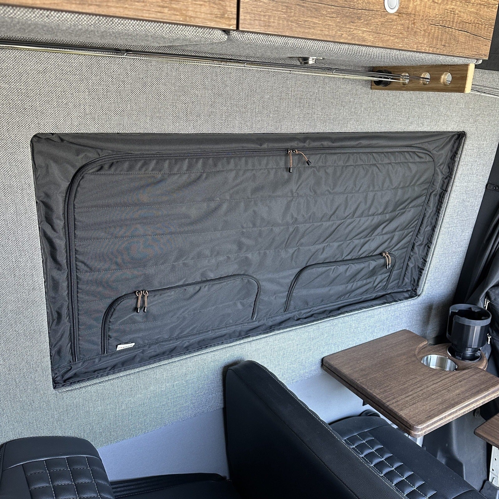 Canyon Adventure Vans CLIMA-SHADE™ insulated groove lounge window cover installed in a vehicle window.