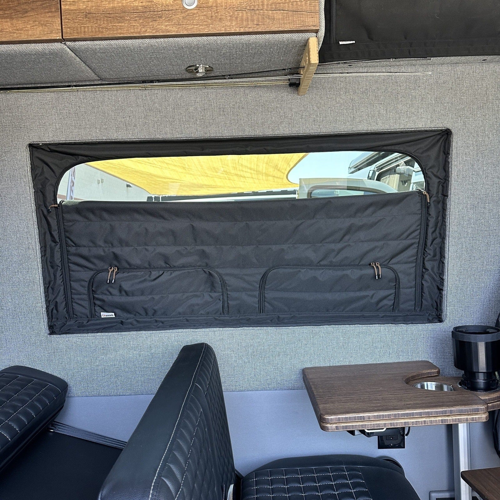 Canyon Adventure Vans CLIMA-SHADE™ insulated groove lounge window cover installed in a van, providing sun insulation and privacy.
