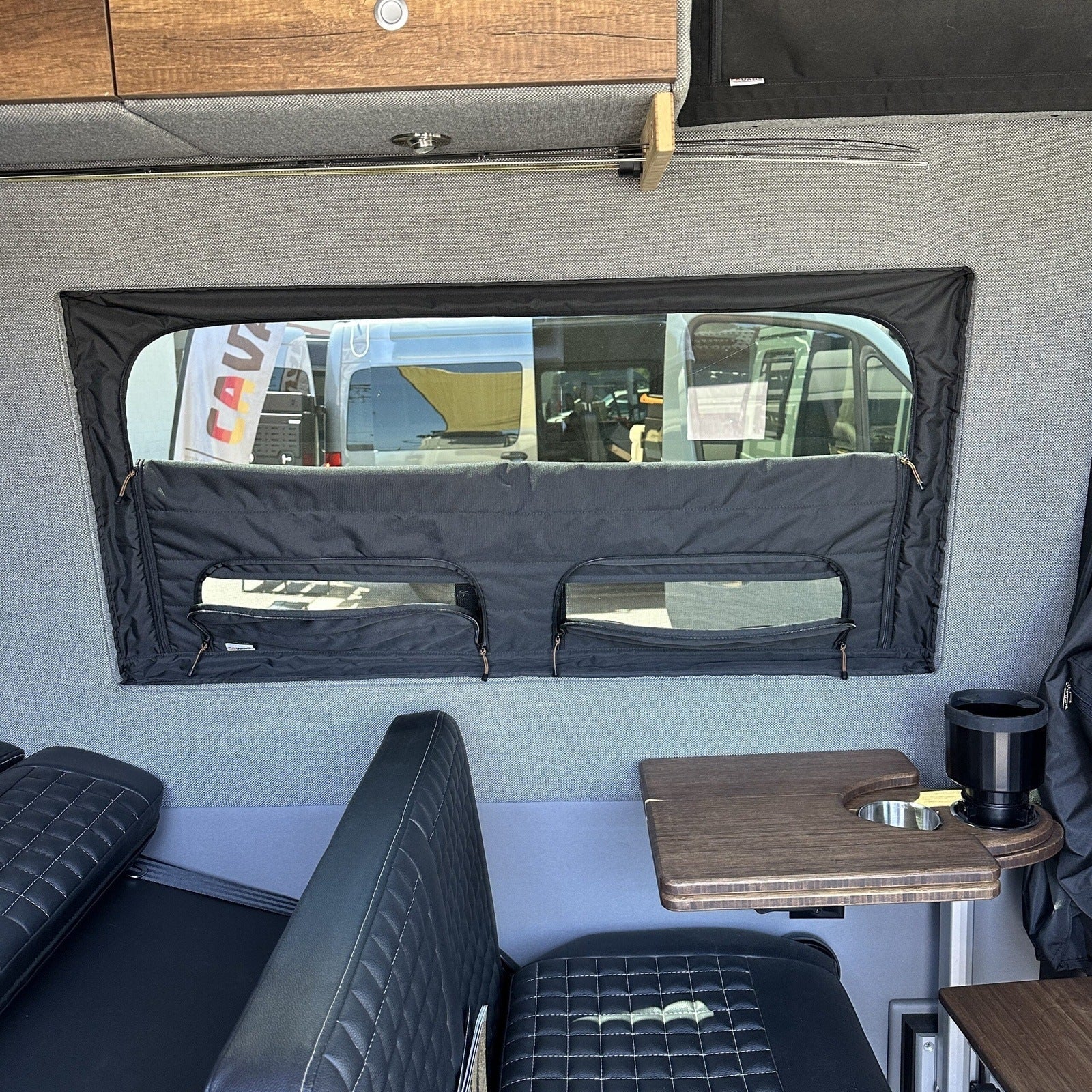 Canyon Adventure Vans CLIMA-SHADE™ insulated groove lounge window cover installed in a vehicle for temperature control and privacy.